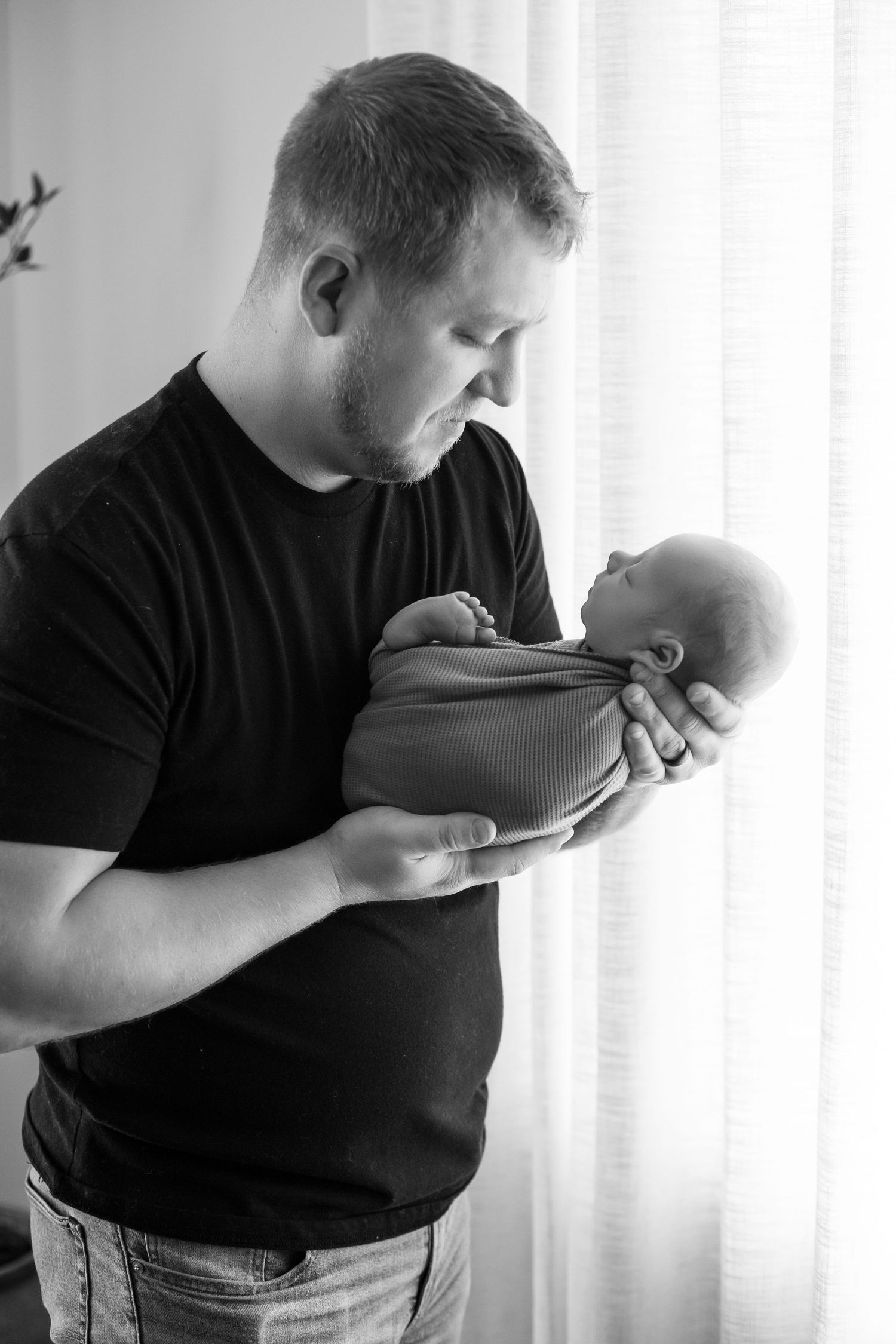 Dad holding newborn son Southeast Minnesota