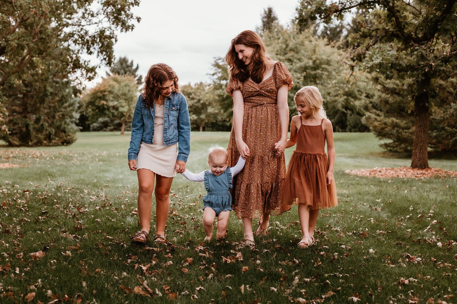 Four sisters walking in in grassy field Southeast Minnesota