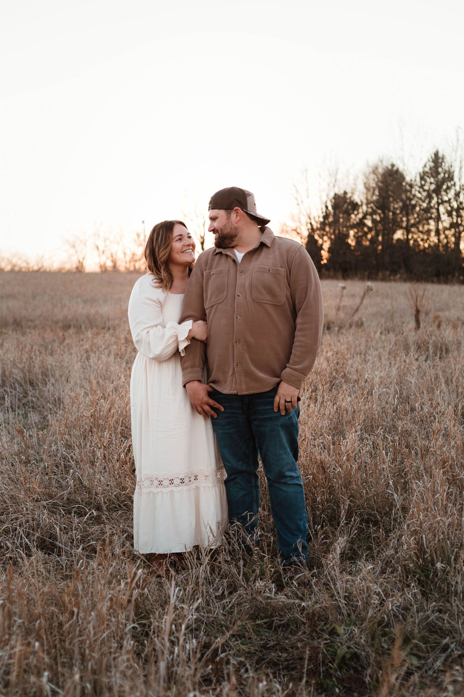 Couple holding each other in grassy field Southeast Minnesota