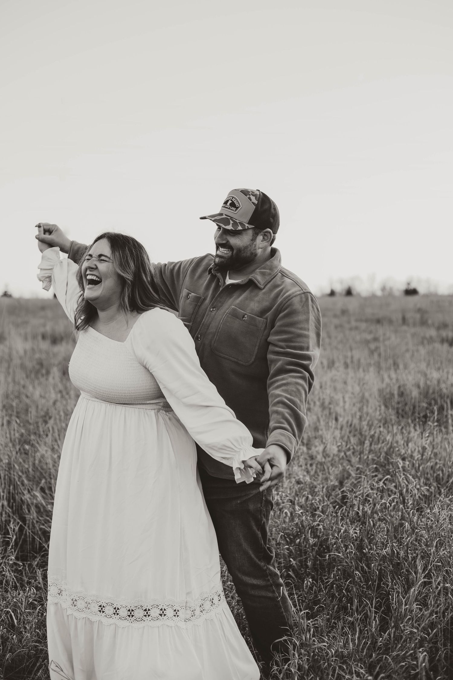 Couple playing in grass field southeast minnesota