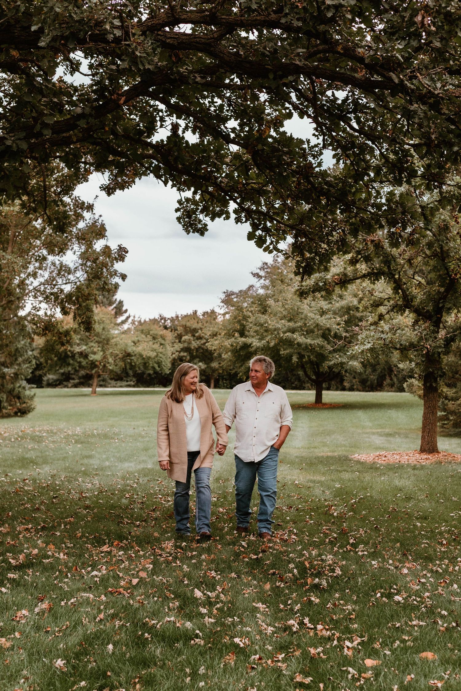 Couple walking in grassy field Southeast Minnesota