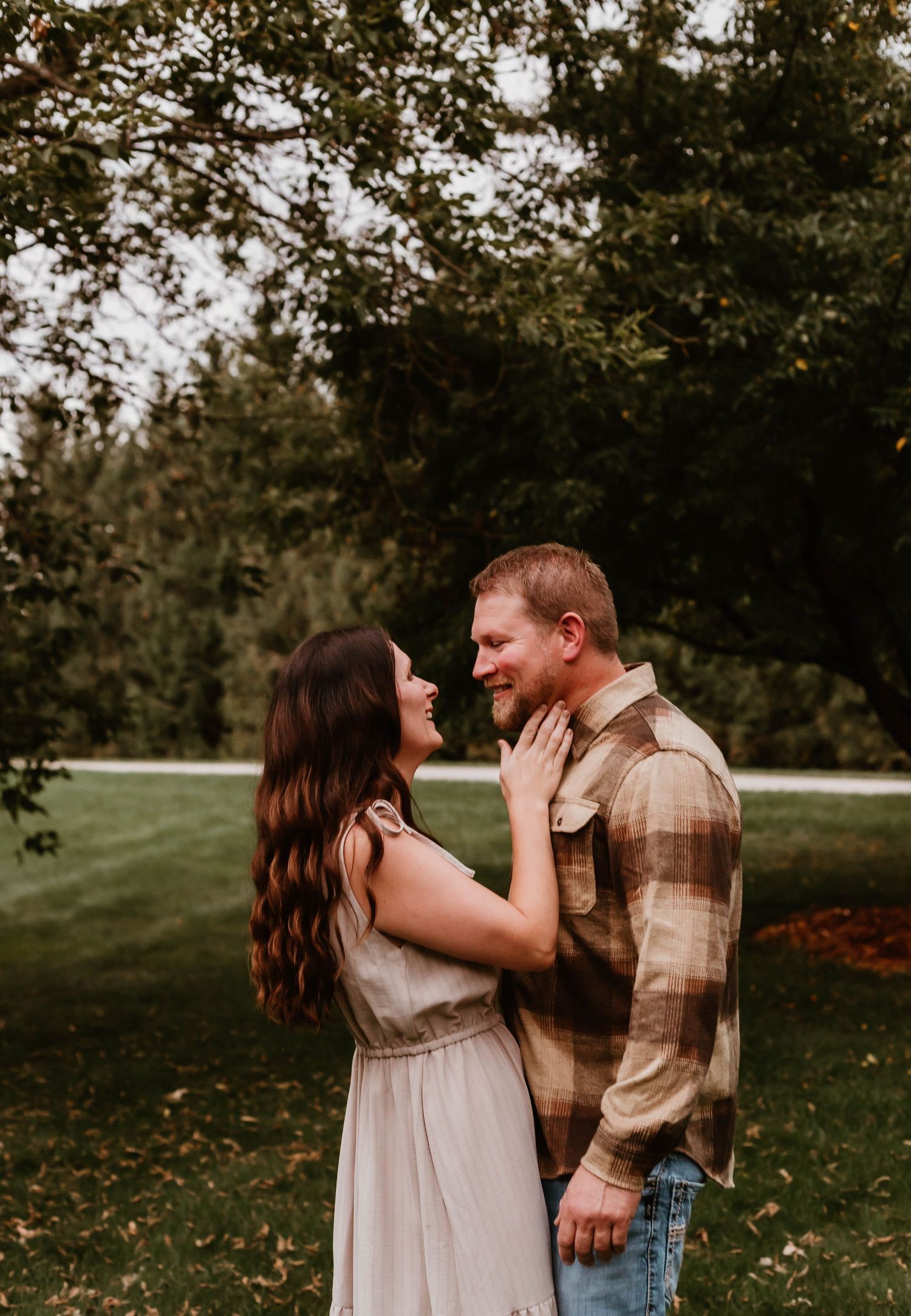 Couple looking at each other in field southeast minnesota