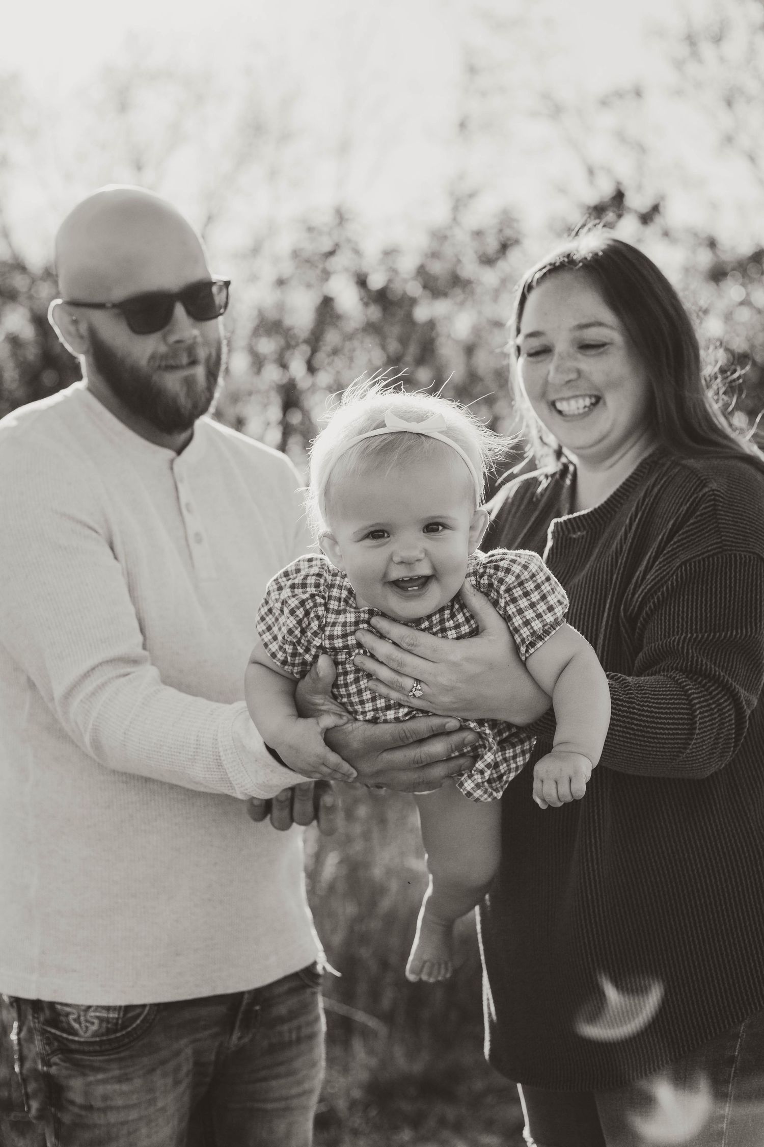 Family of 3 in sunny, grassy field Southeast Minnesota
