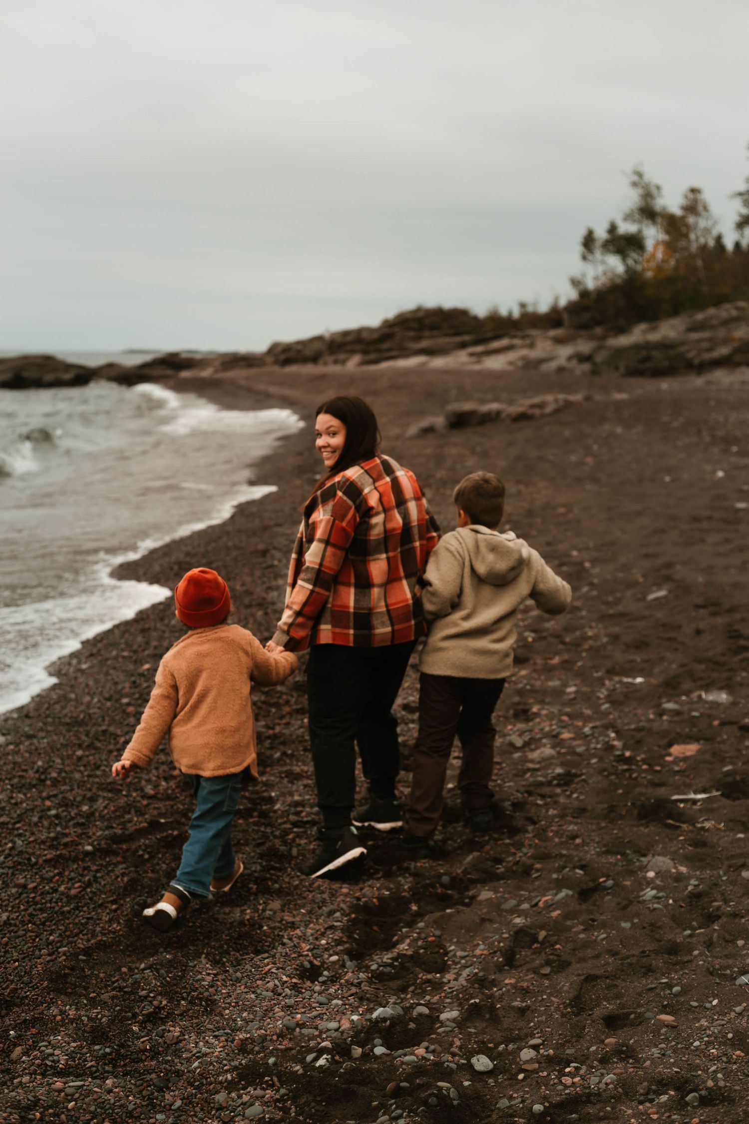 Mom and children walking away from camera in Northern Minnesota