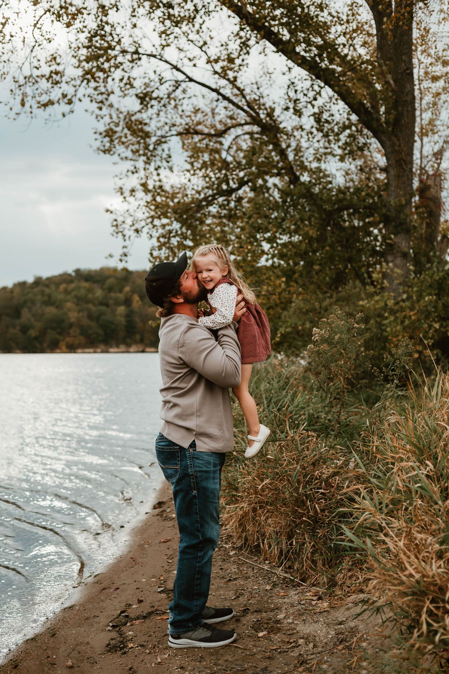 Dad and daughter on lakeshore in Minnesota