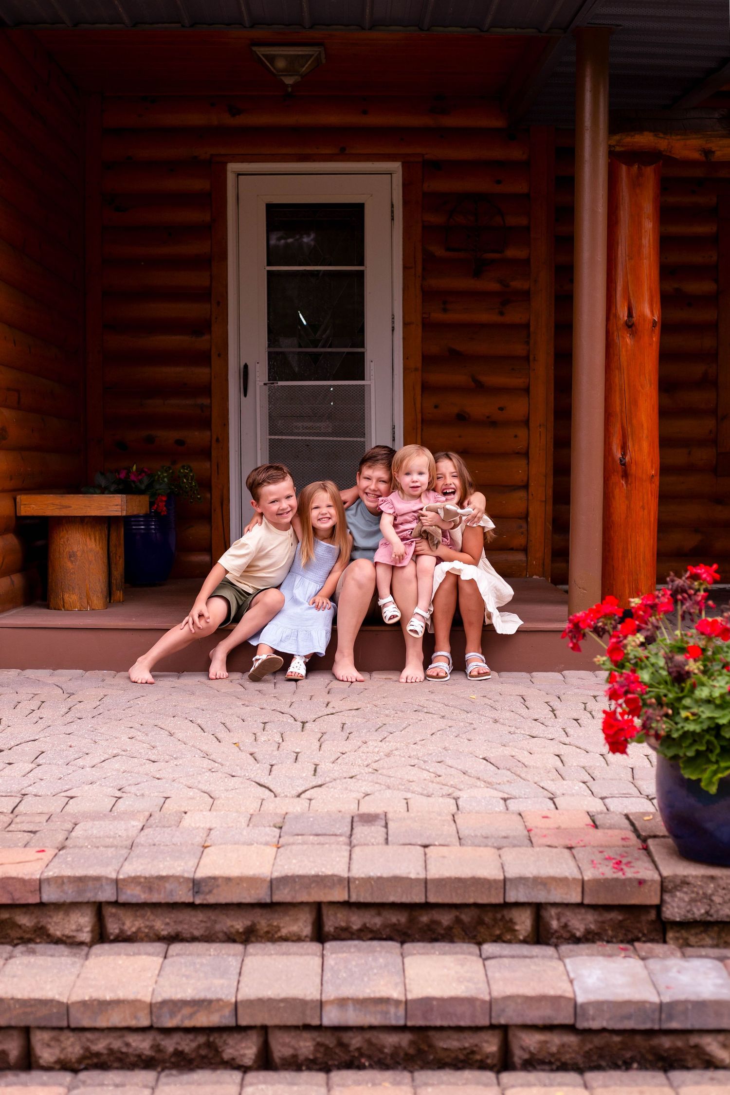 Group of kids in front of lake house Minnesota