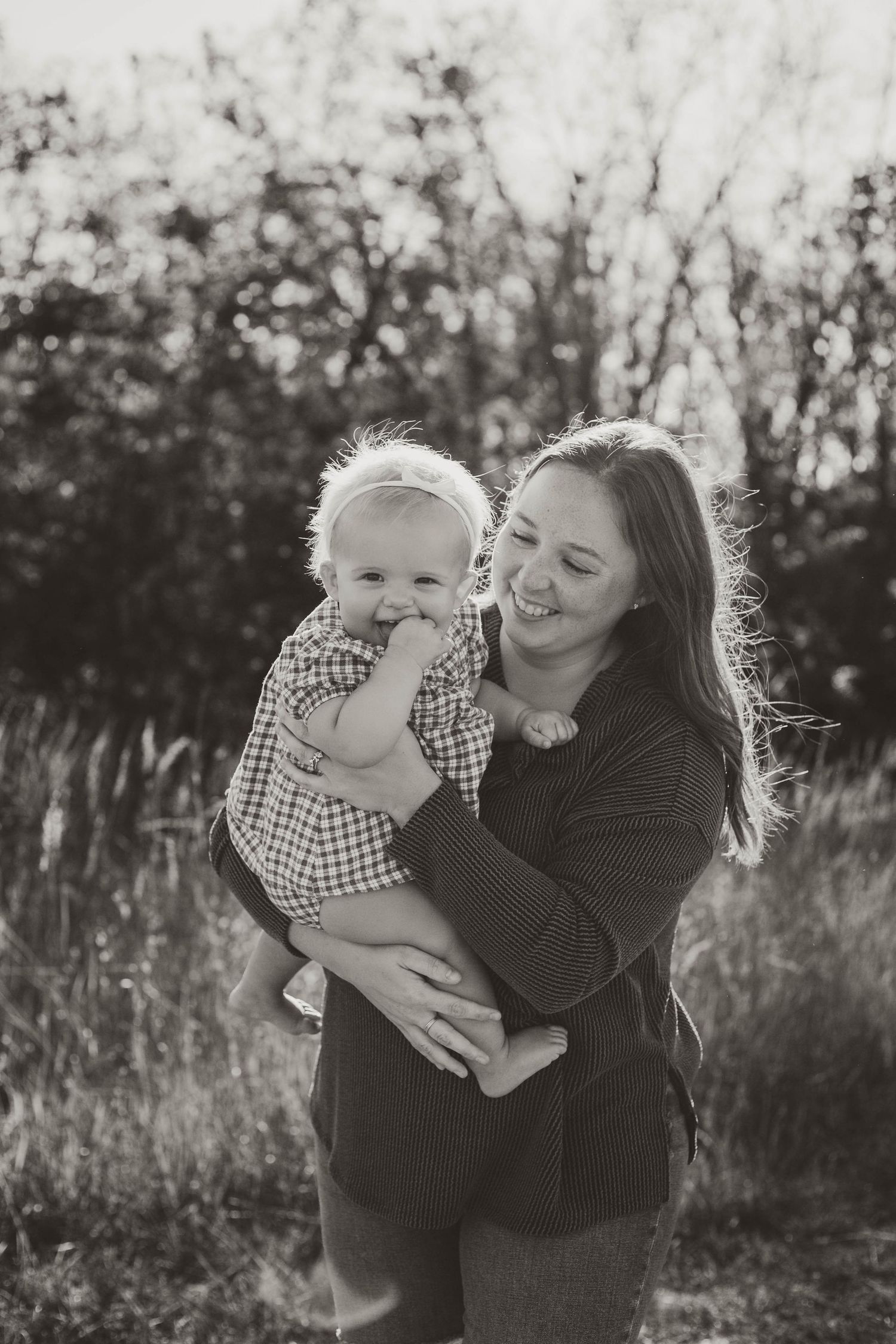 Mom and baby in sunny, grassy field Southeast Minnesota