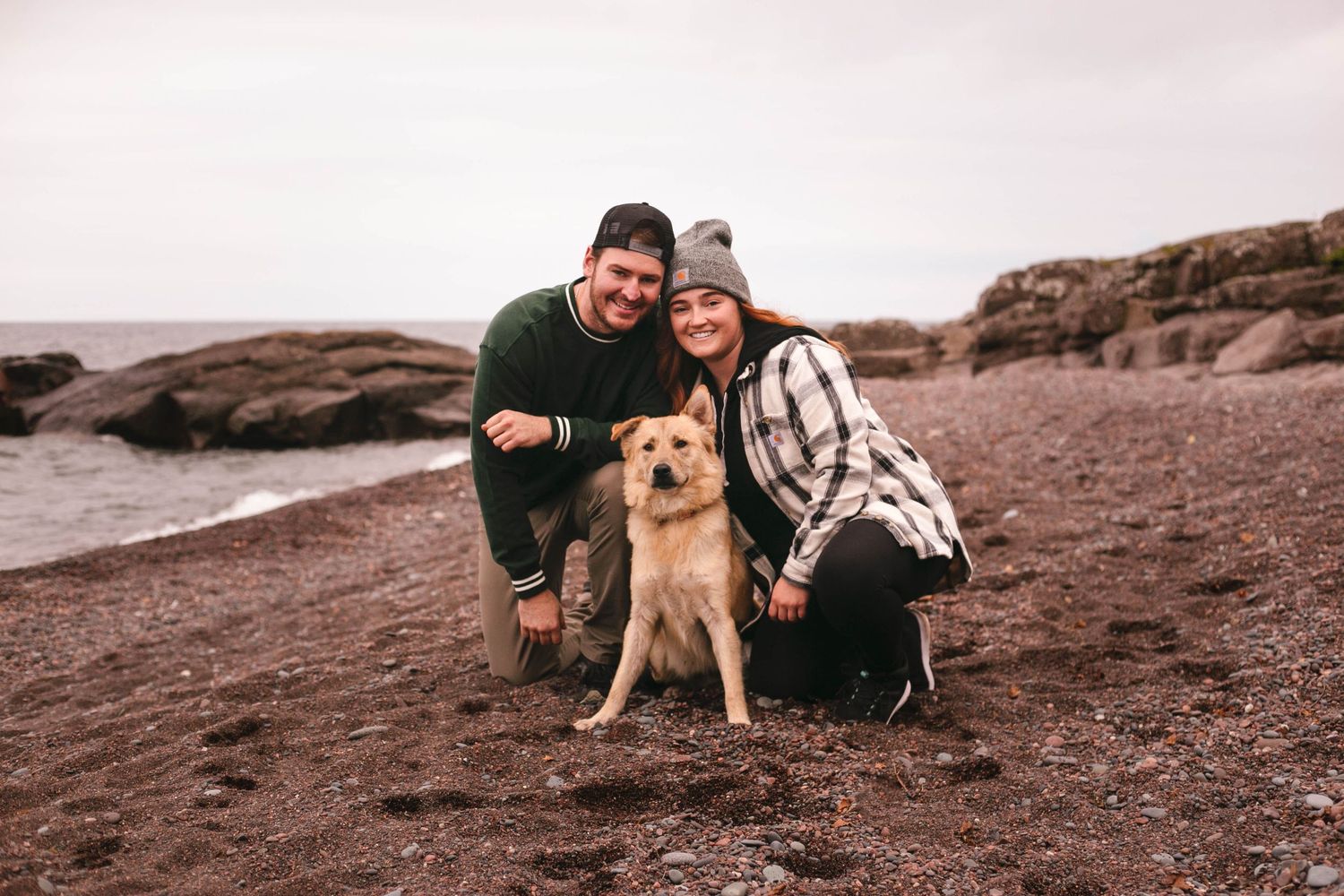 couple with dog on beach minnesota