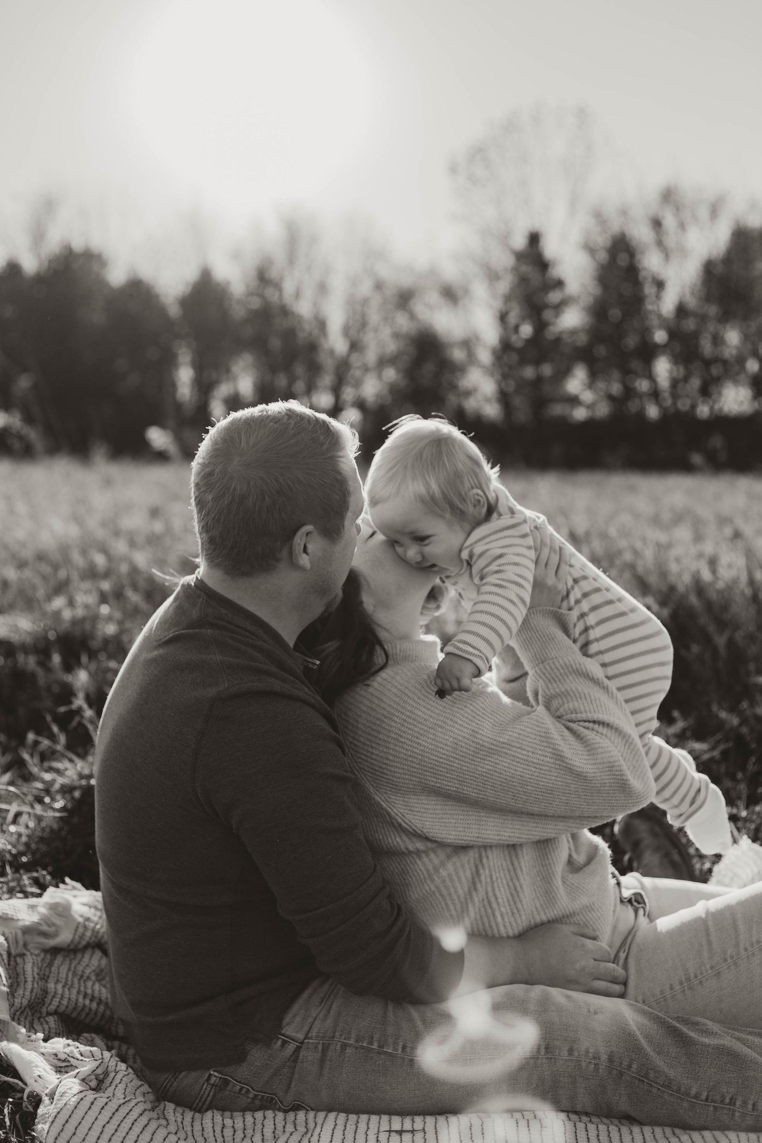 Family of 3 in grassy field Southeast Minnesota