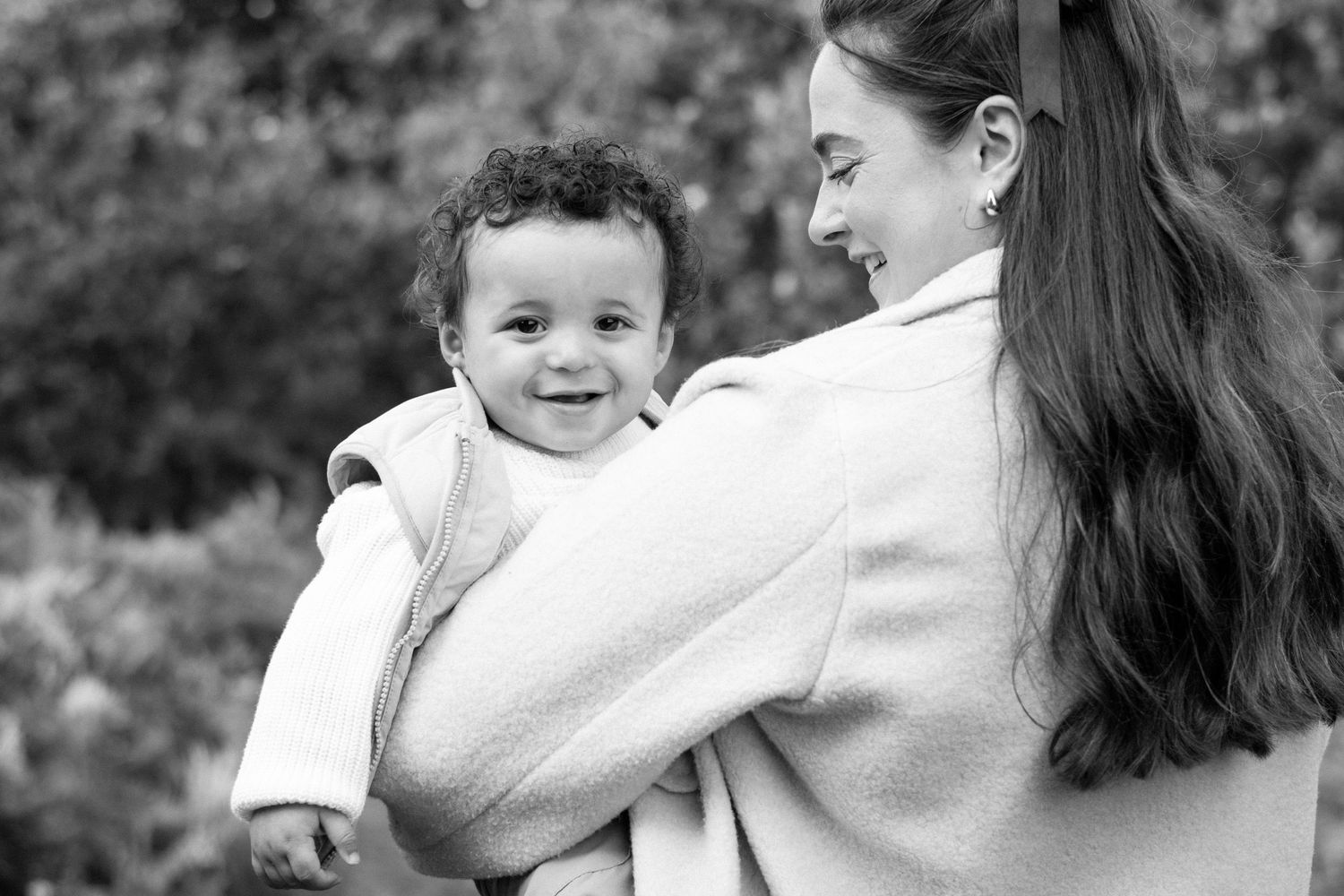 Tender family portrait session in a natural outdoor setting.