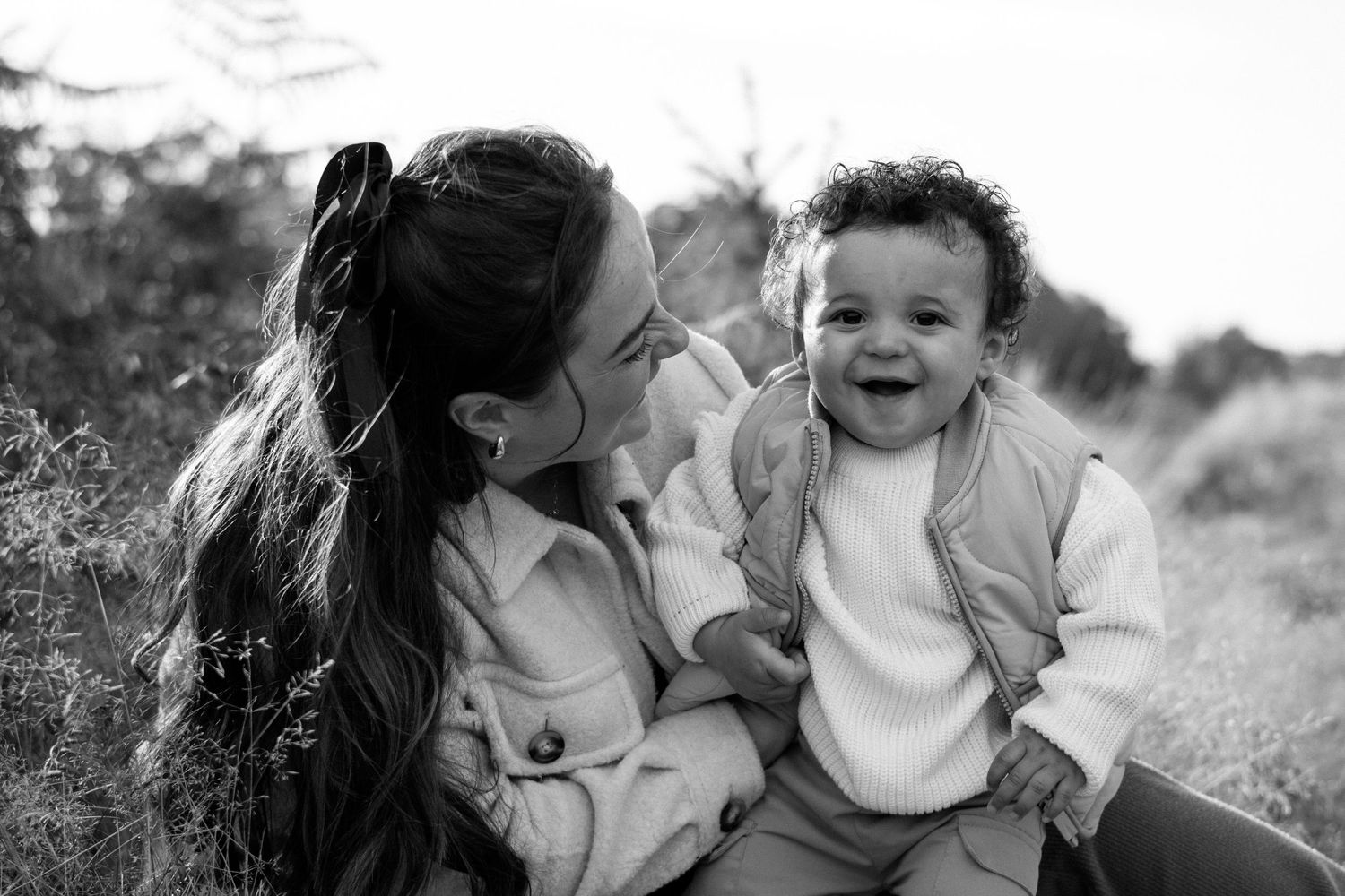Black and white family portraits showing joyful expressions and connections.