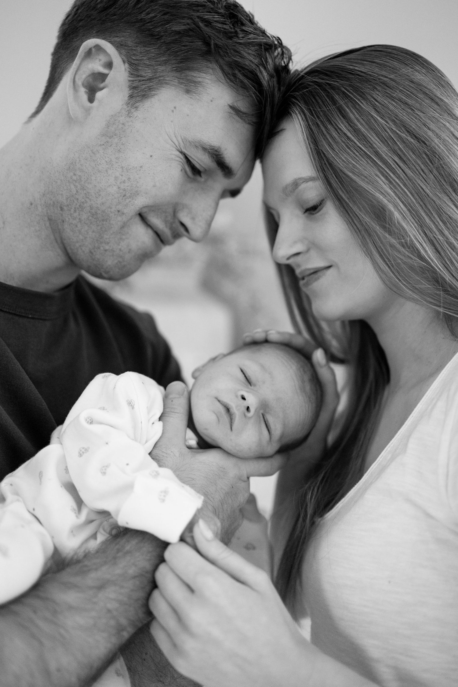 Black and white romantic photo collage showing intimate close-up moments between a couple.
