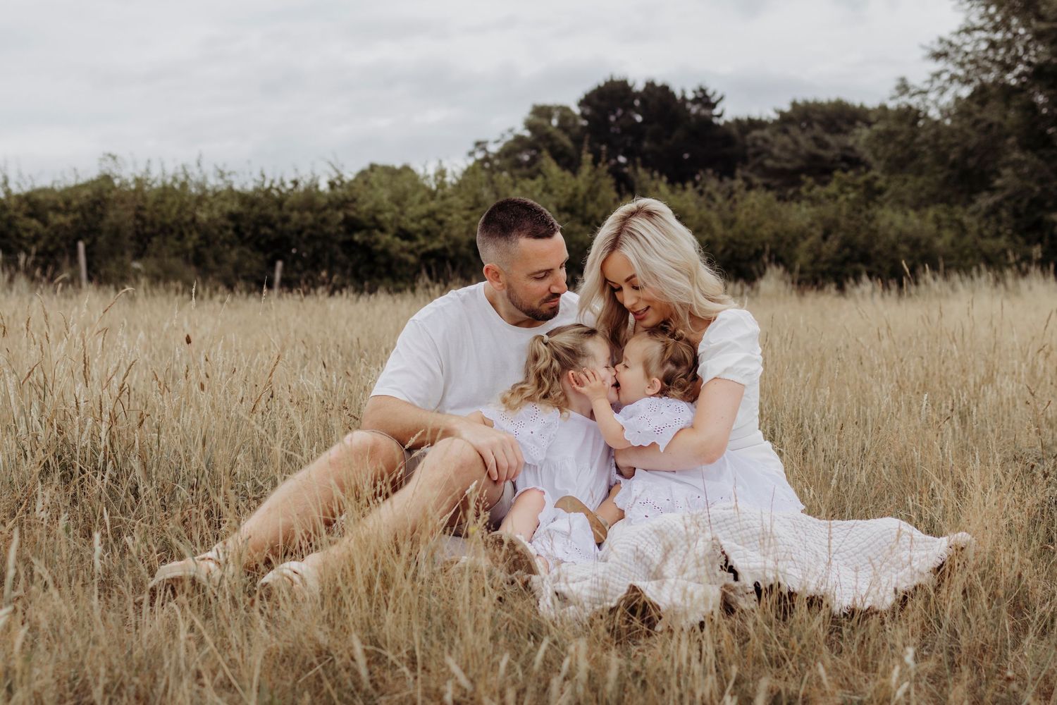 Natural lifestyle family photography session in an outdoor meadow setting.