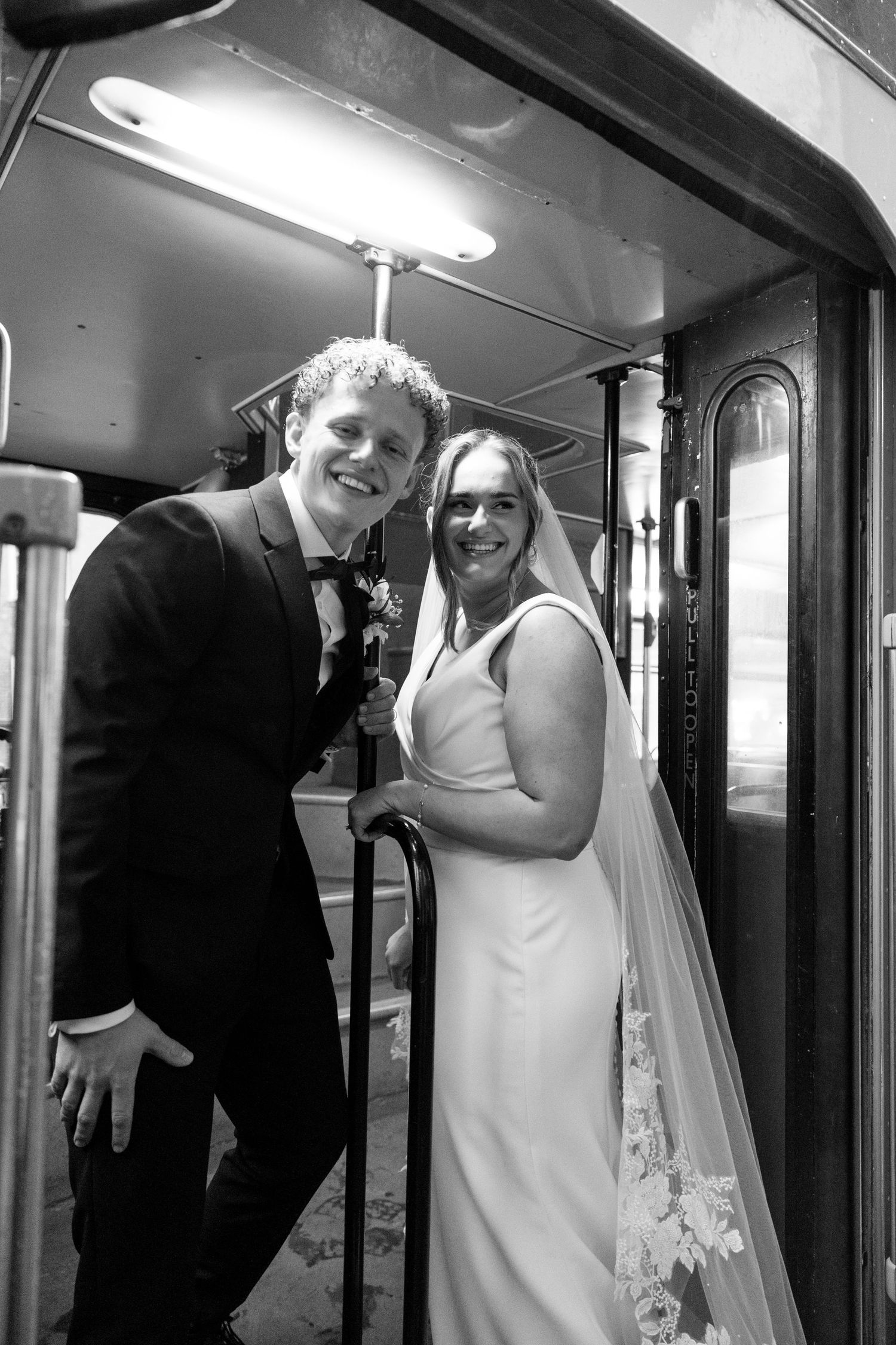 Candid black and white wedding moments captured in a hallway setting.