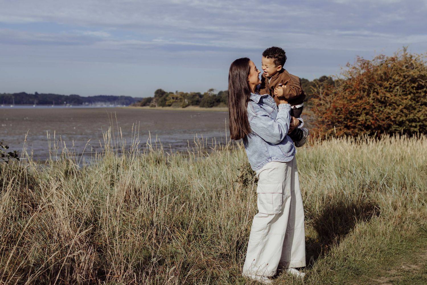 Romantic photoshoot in a coastal marsh landscape during golden hour.