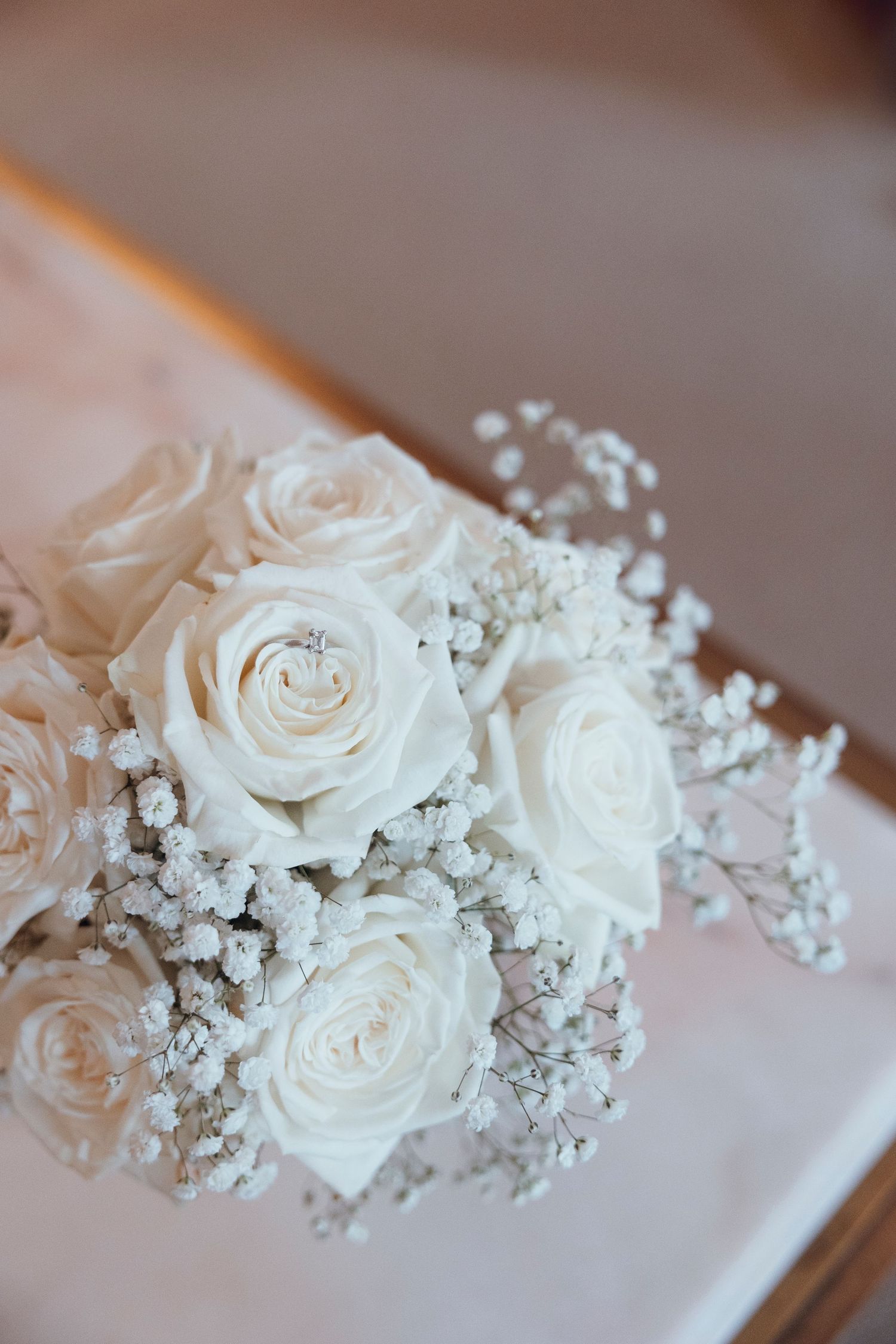 White roses and baby's breath wedding bouquet detail shot.
