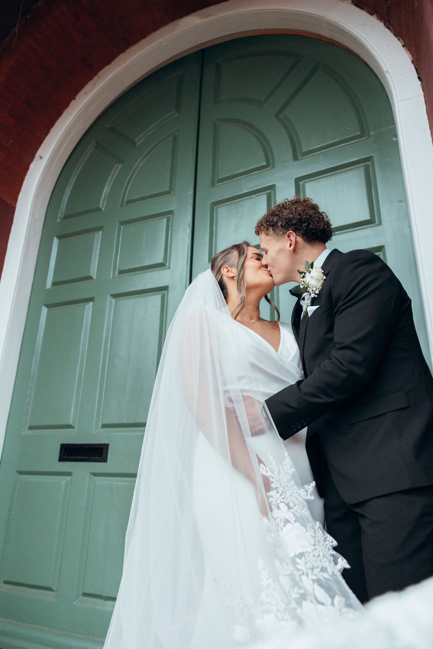 Romantic wedding sequence against a mint green door showing tender moments between newlyweds.