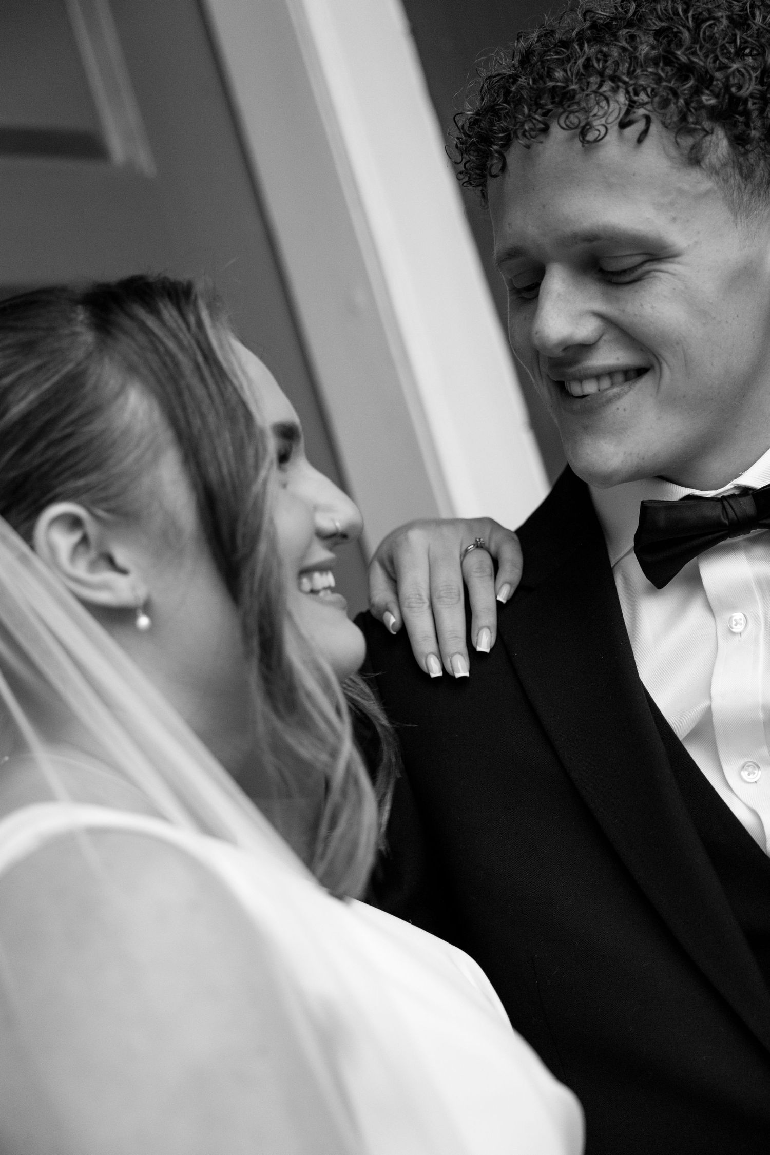 Intimate black and white close-up shots of newlyweds sharing tender moments.