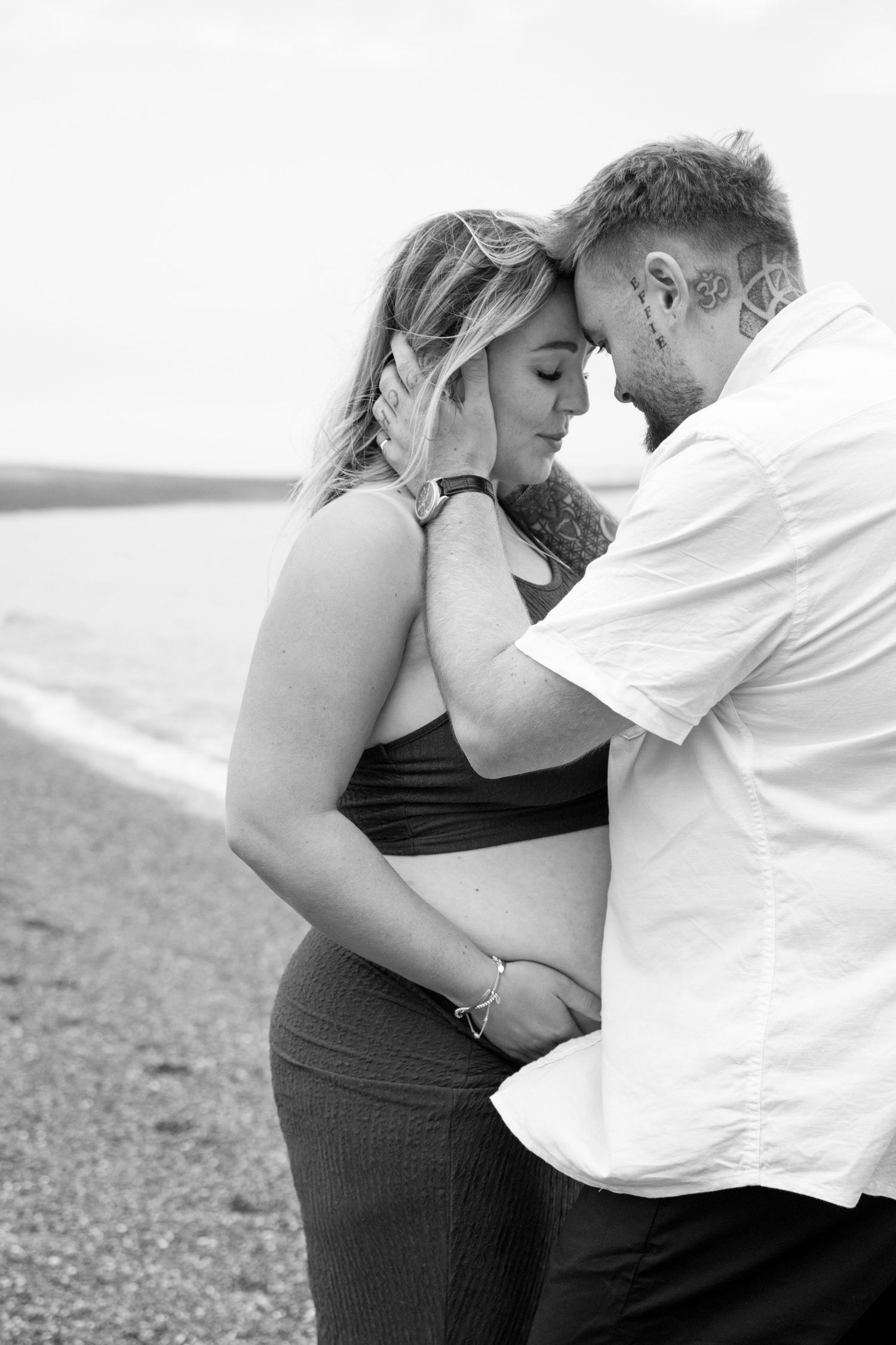 A romantic black and white photo series showing an intimate couple embracing in four progressive shots.