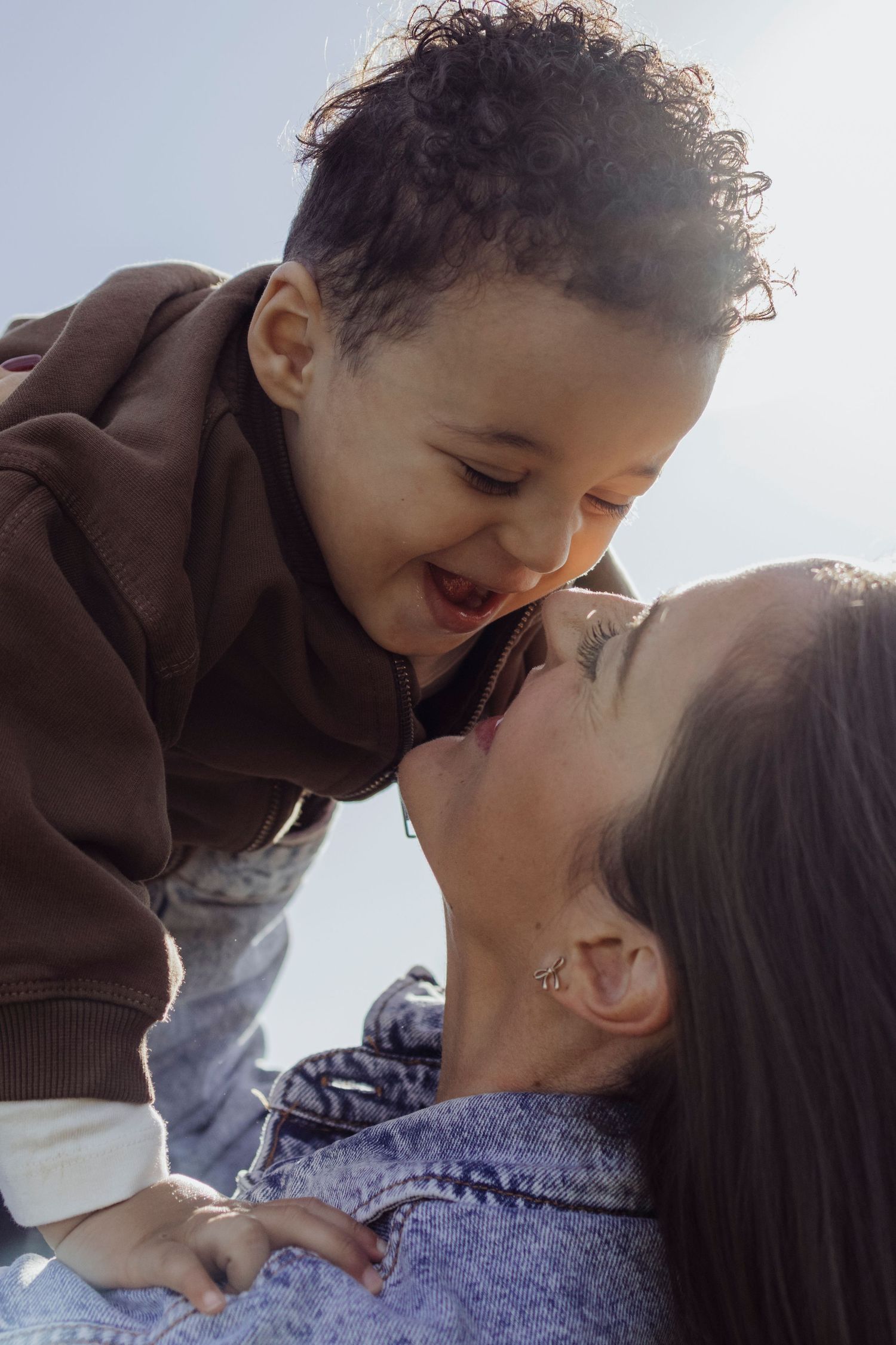 Sweet candid moments of family affection captured in bright natural light.