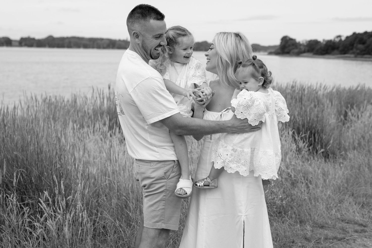 Natural outdoor sequence of tender family moments in a rustic field setting.