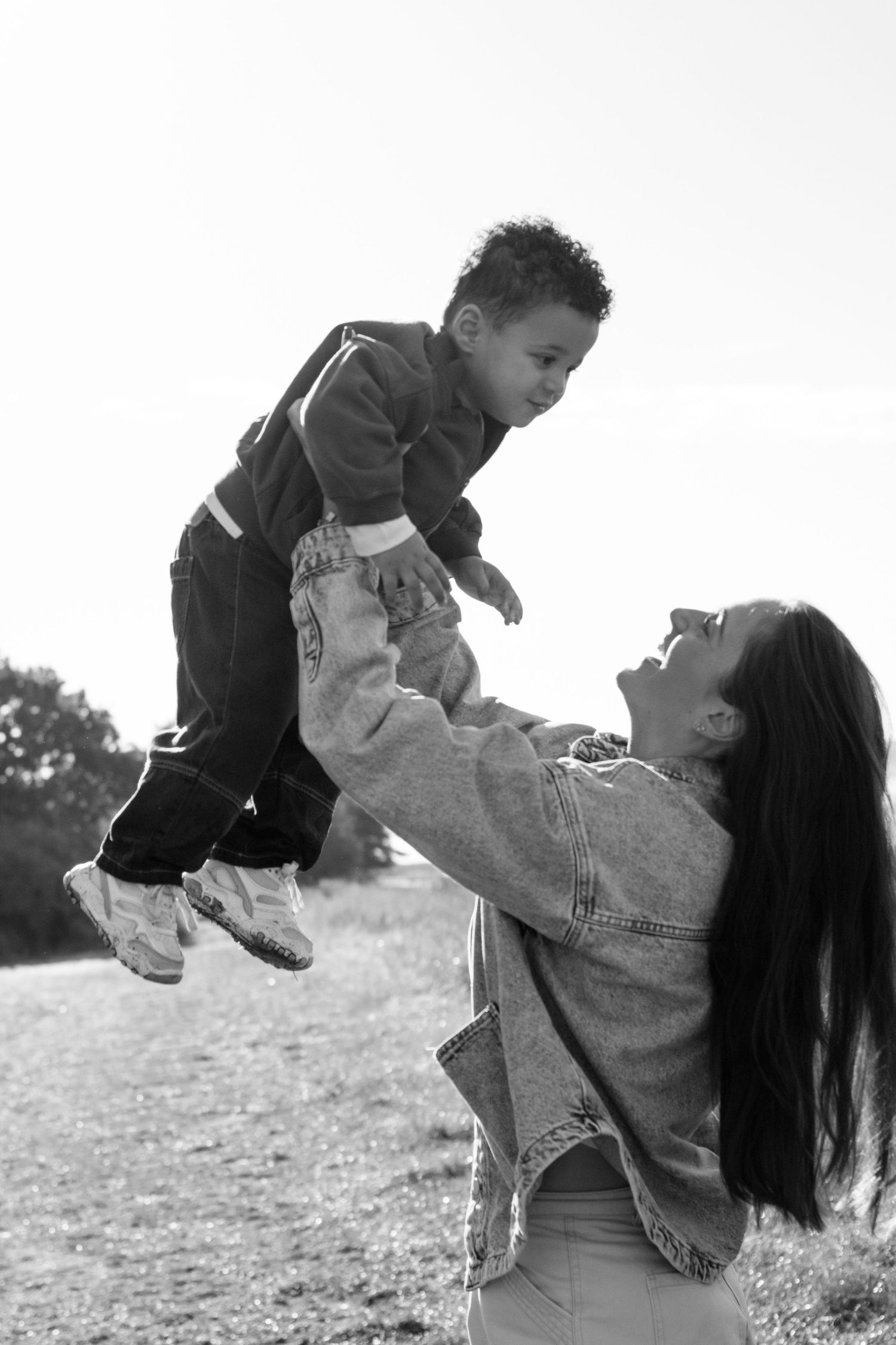 Black and white candid moments captured in a grassy field.
