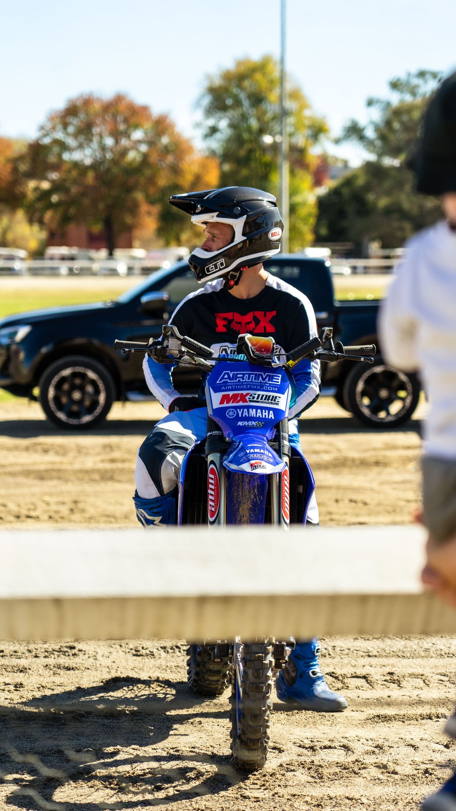 Dirt race track with motocross riders preparing for competition.