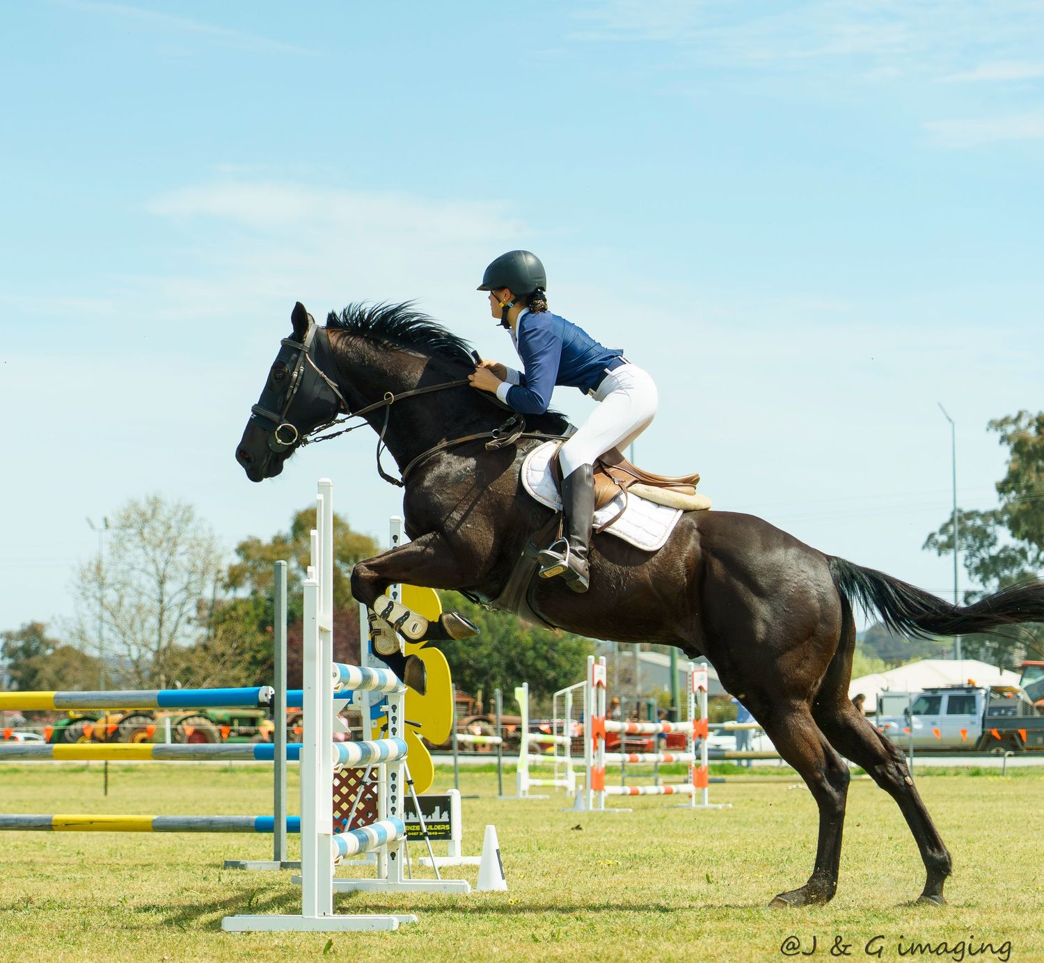 Horse and rider clearing a show jumping fence during equestrian competition.