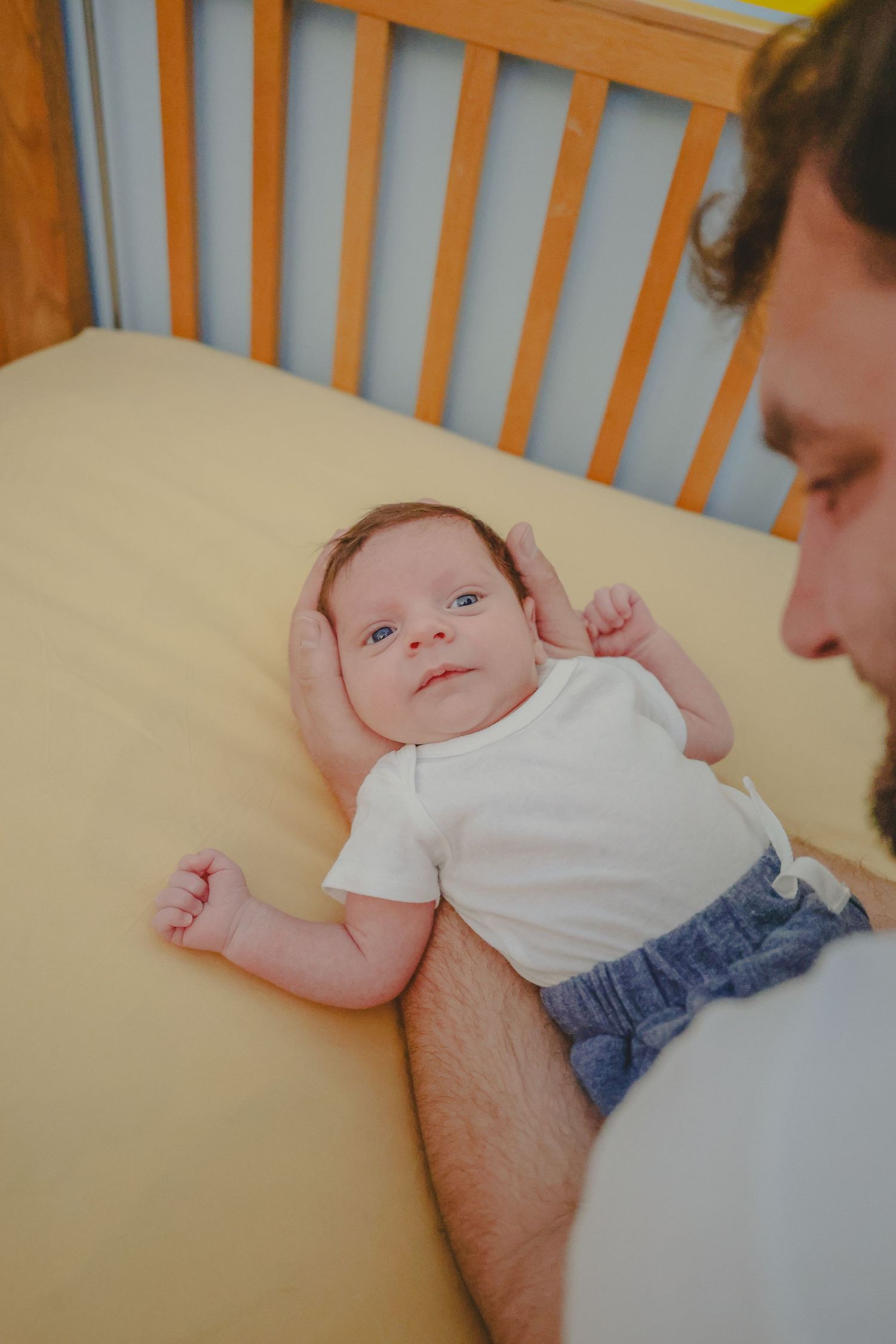 Family lifestyle session featuring dad cuddling baby.