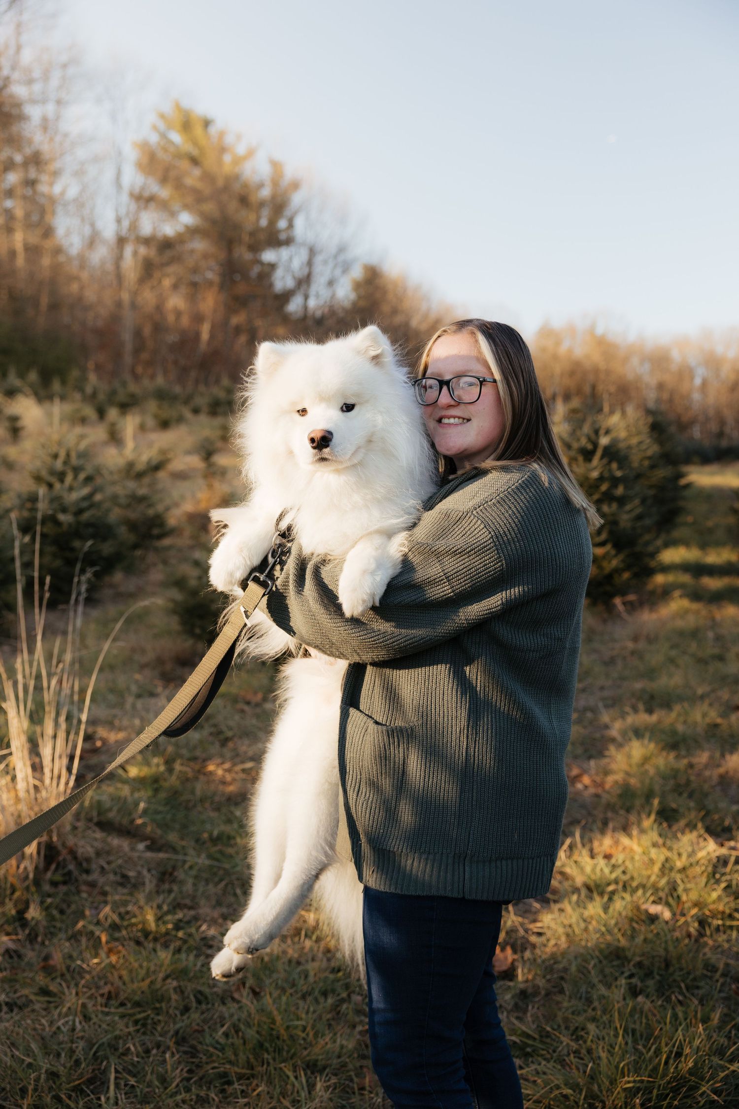 Samoyed and person smiling for photo