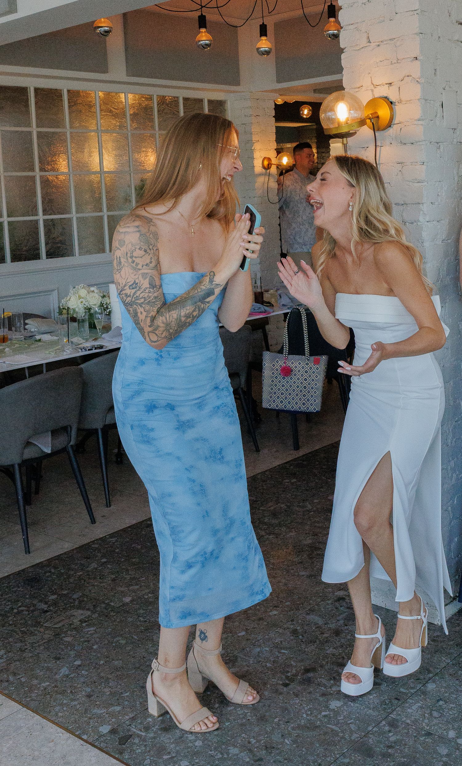 Maid of honor and bride laughing at bridal shower