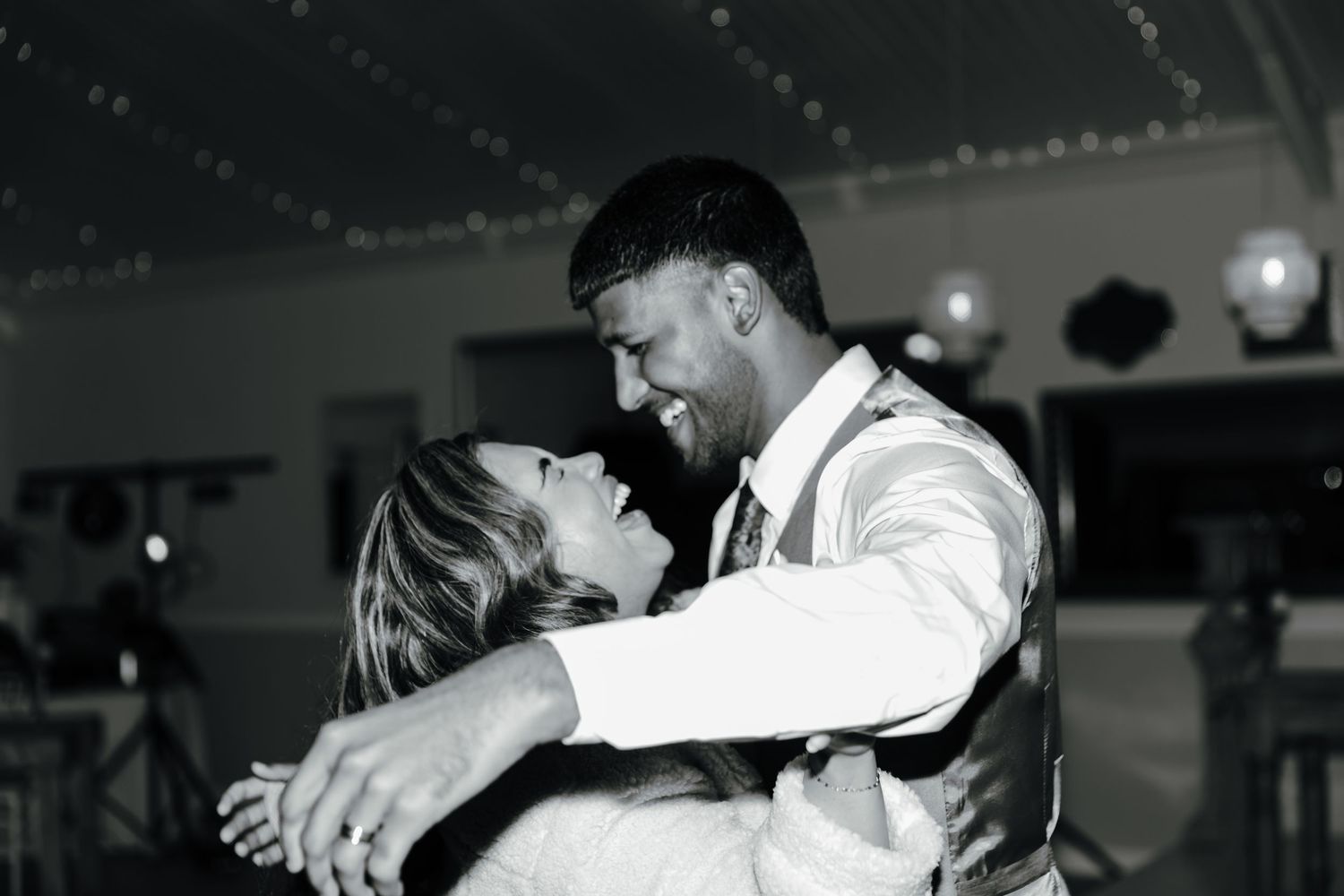 A collection of black and white dance floor moments at a wedding reception.