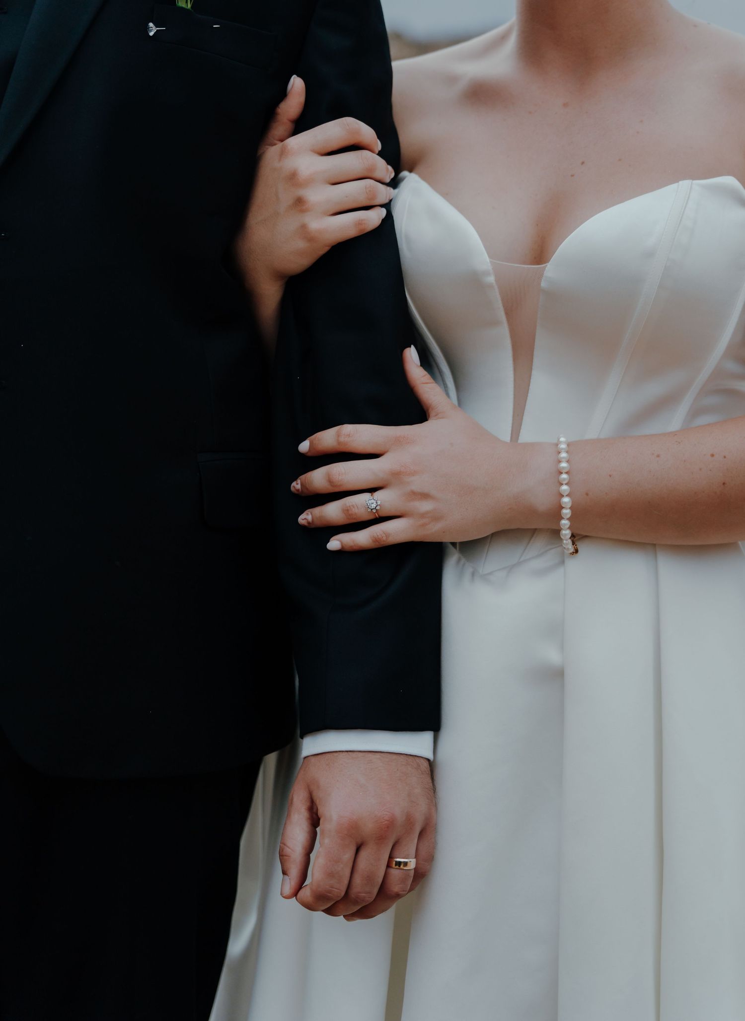 Elegant details of classic white wedding dress with pearl buttons and structured bodice.