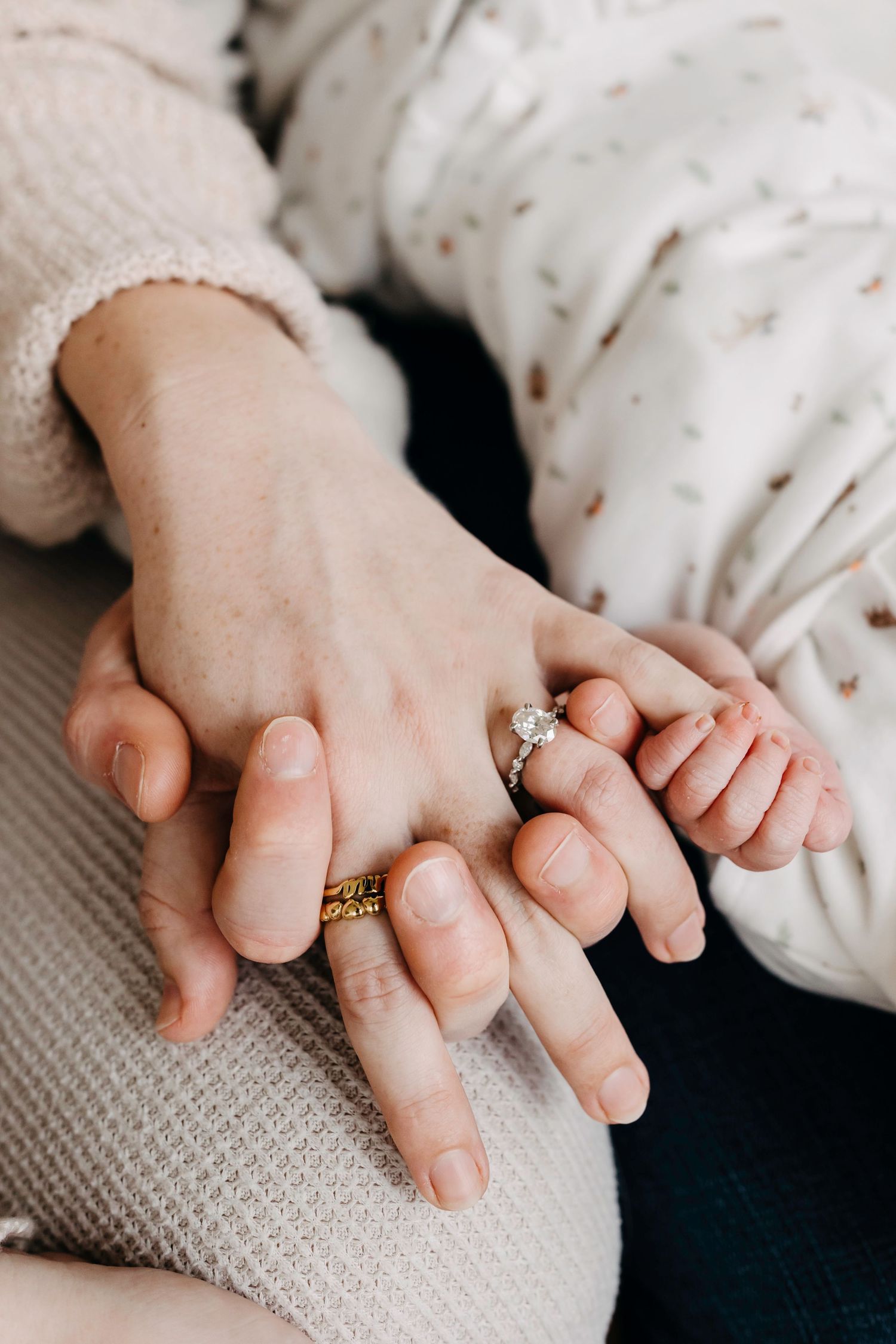 Close up of tiny baby hands grasping a soft knit blanket in a series of tender moments.
