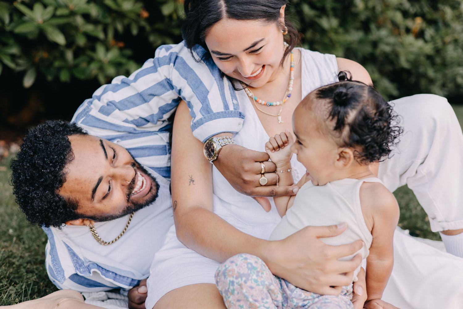 Candid moments of a family laughing and embracing together outdoors in a series of joyful photographs.