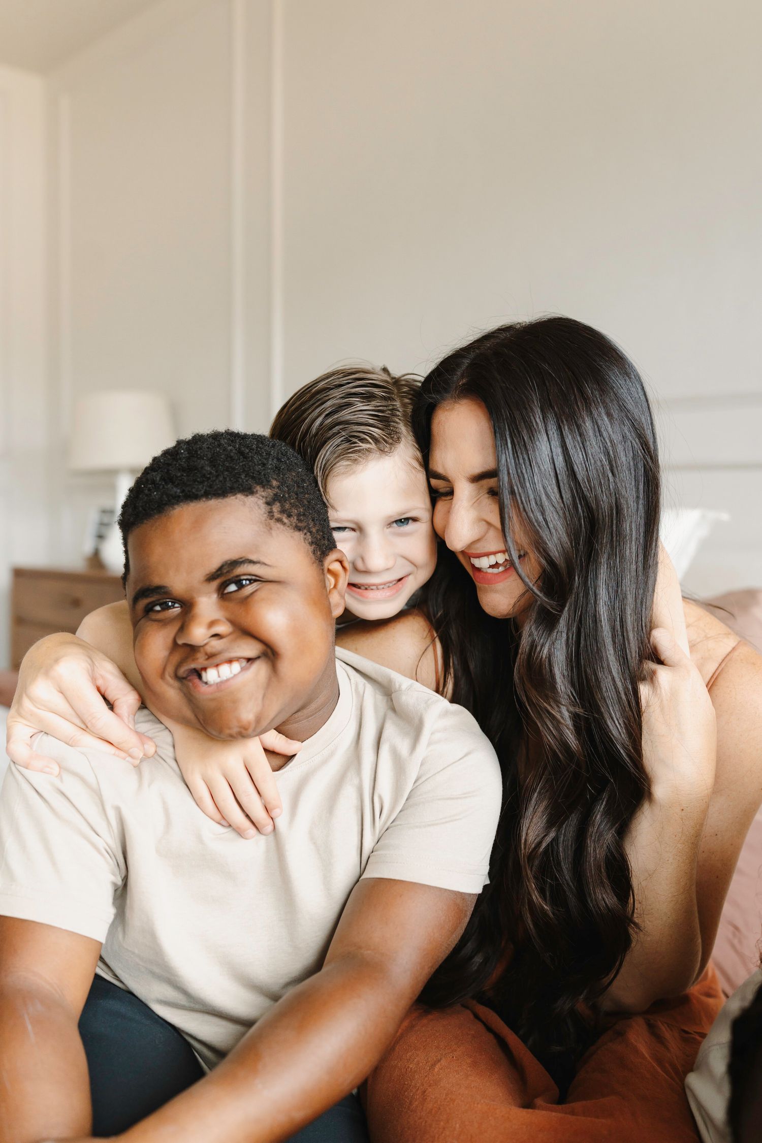 mom leaning into her two sons in a loving moment