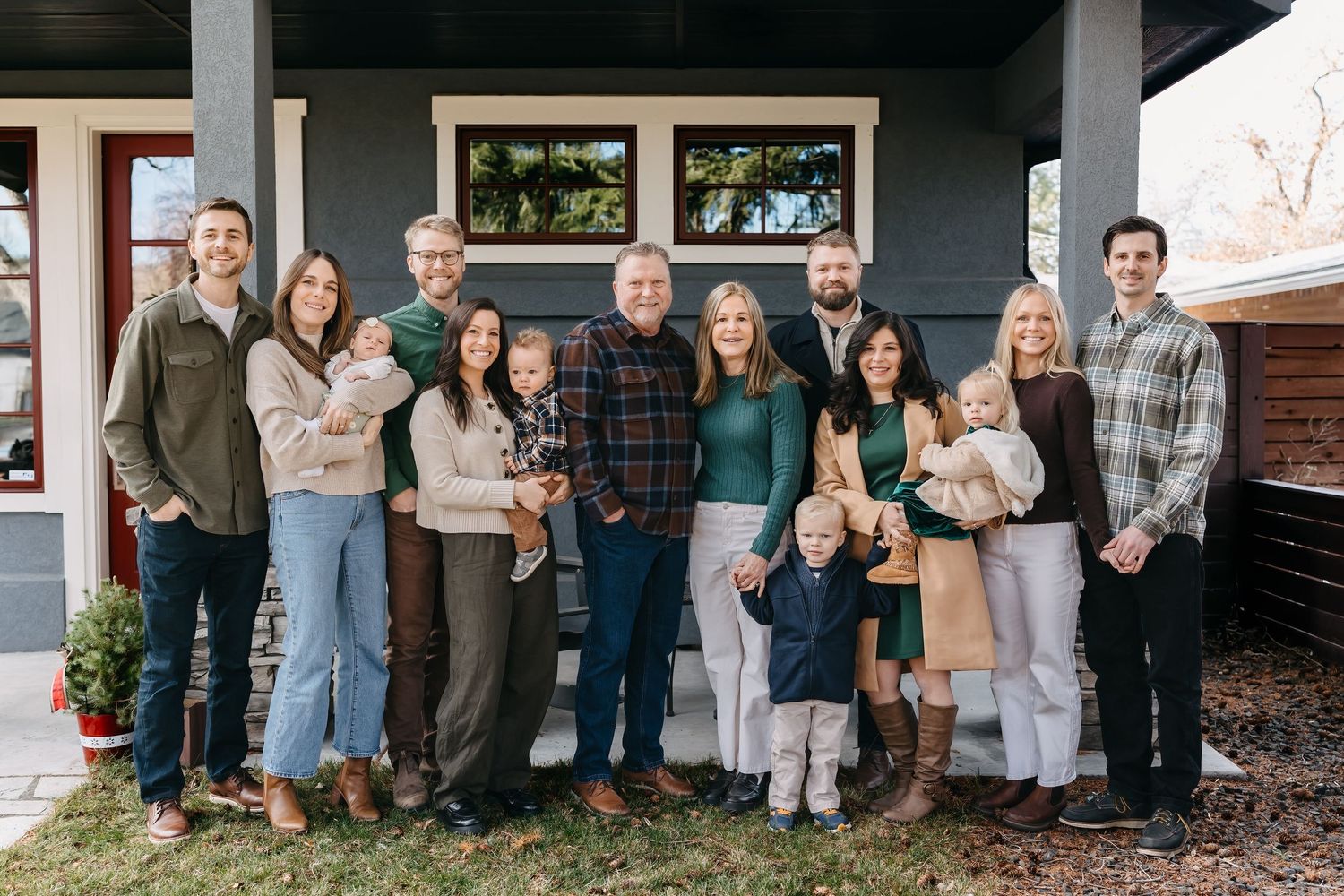 large extended family with multiple generations smiling at the camera for holiday photos in boise idaho