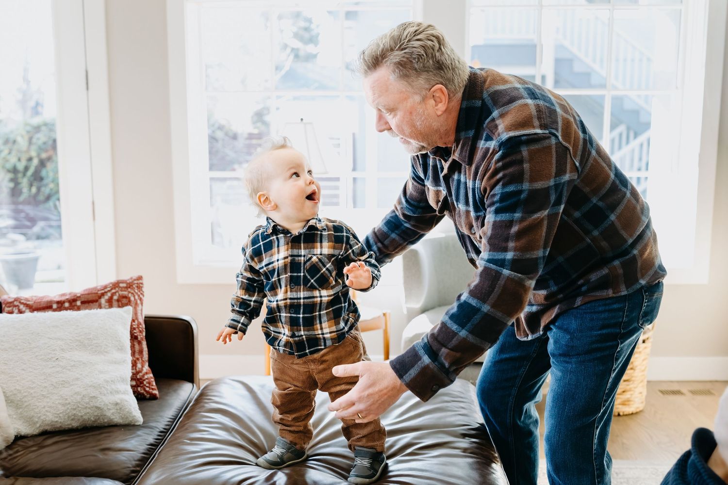 grandpa plays with toddler grandchild