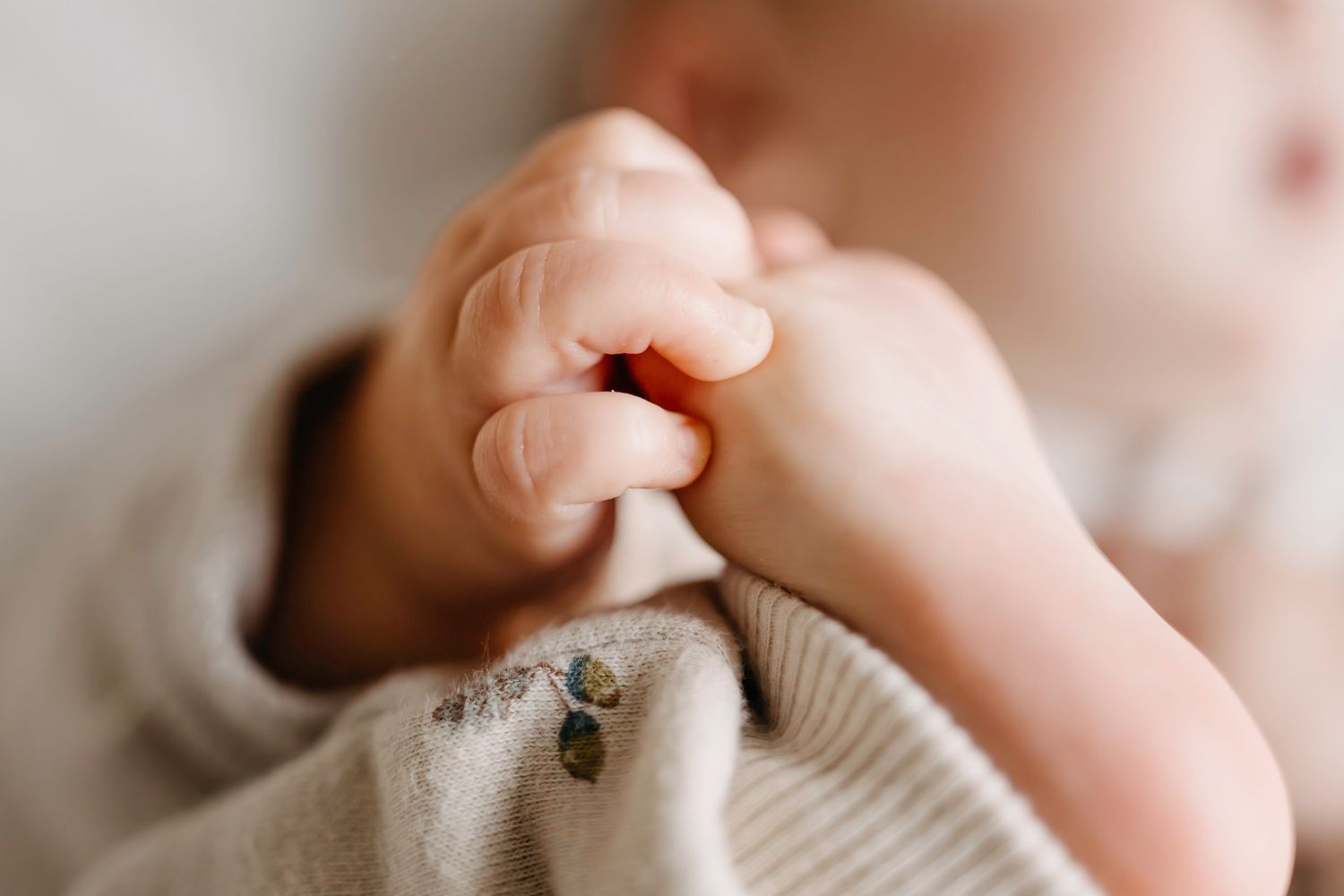Close up of baby hold his little feet during a newborn photoshoot