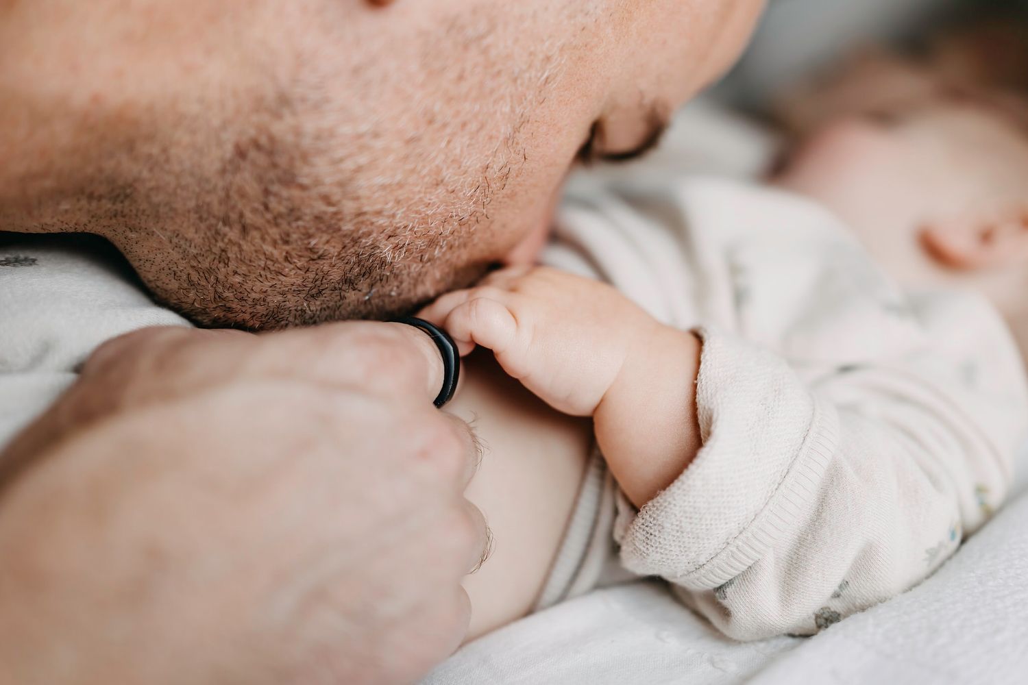 Close-up view of a dad kissing baby