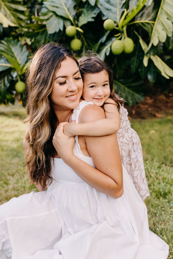 A tender moment of affection and embraces captured in a series of outdoor portraits against a natural garden backdrop.