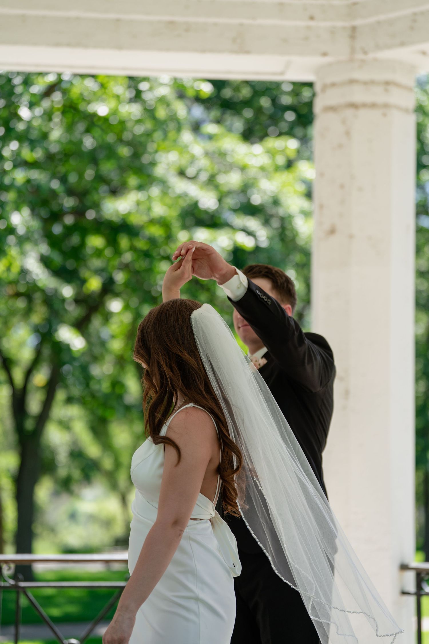Wedding couple shares intimate moments in sequence of candid shots on a white columned porch.