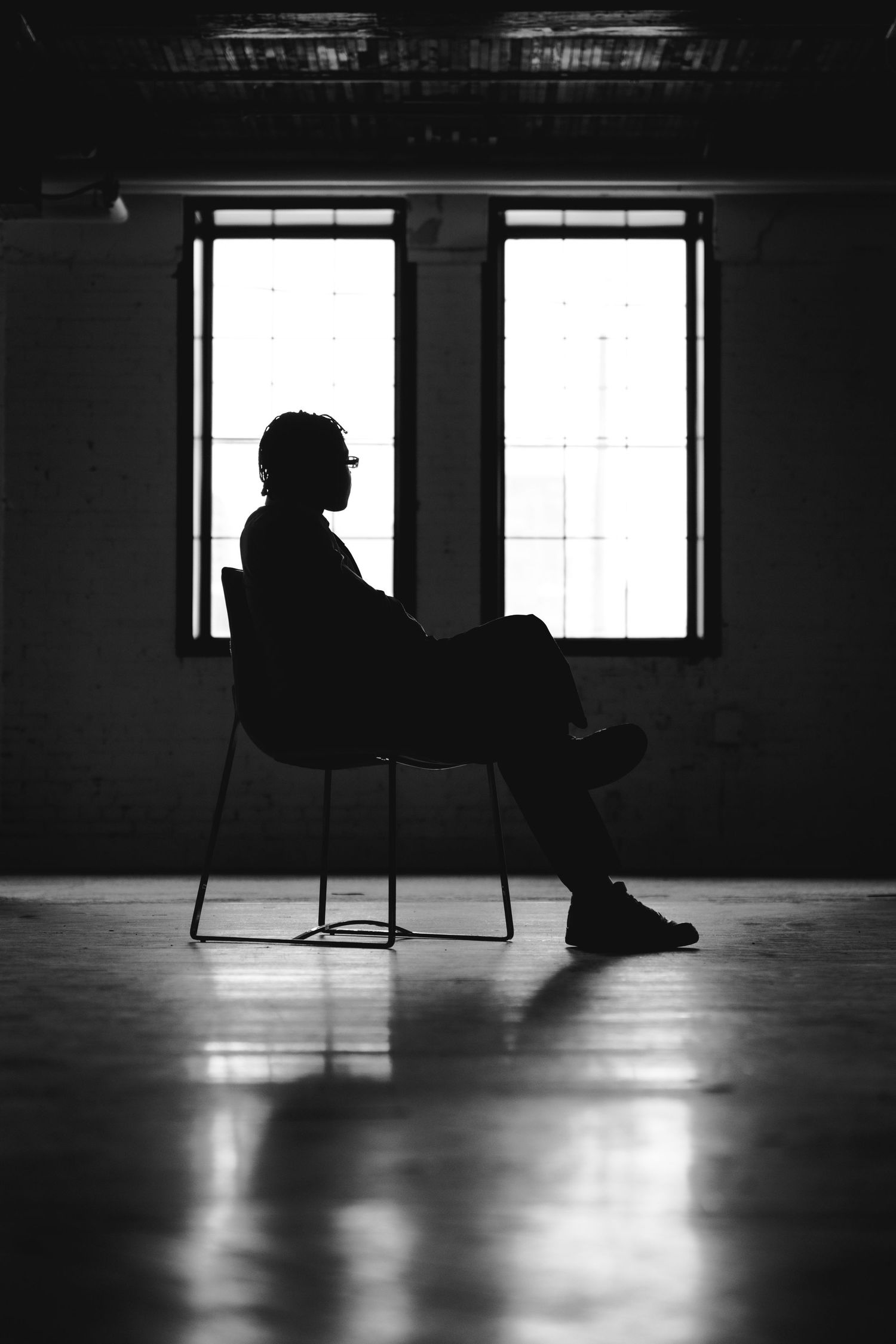 Dramatic silhouette series showing a figure reclining on the floor in a sunlit room.