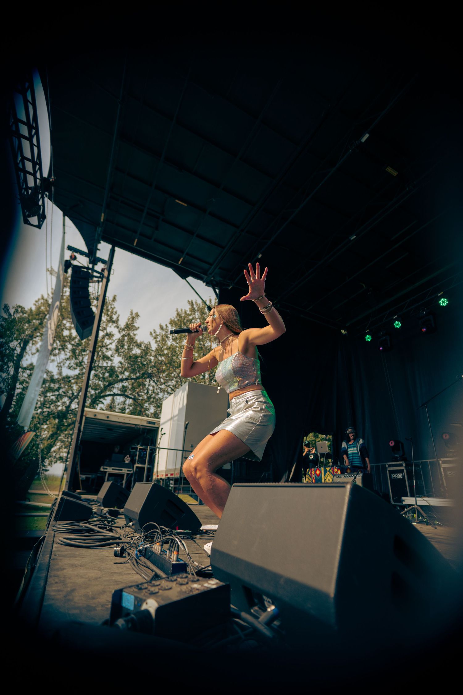 Dynamic performance shots of musician jumping and moving energetically on stage.