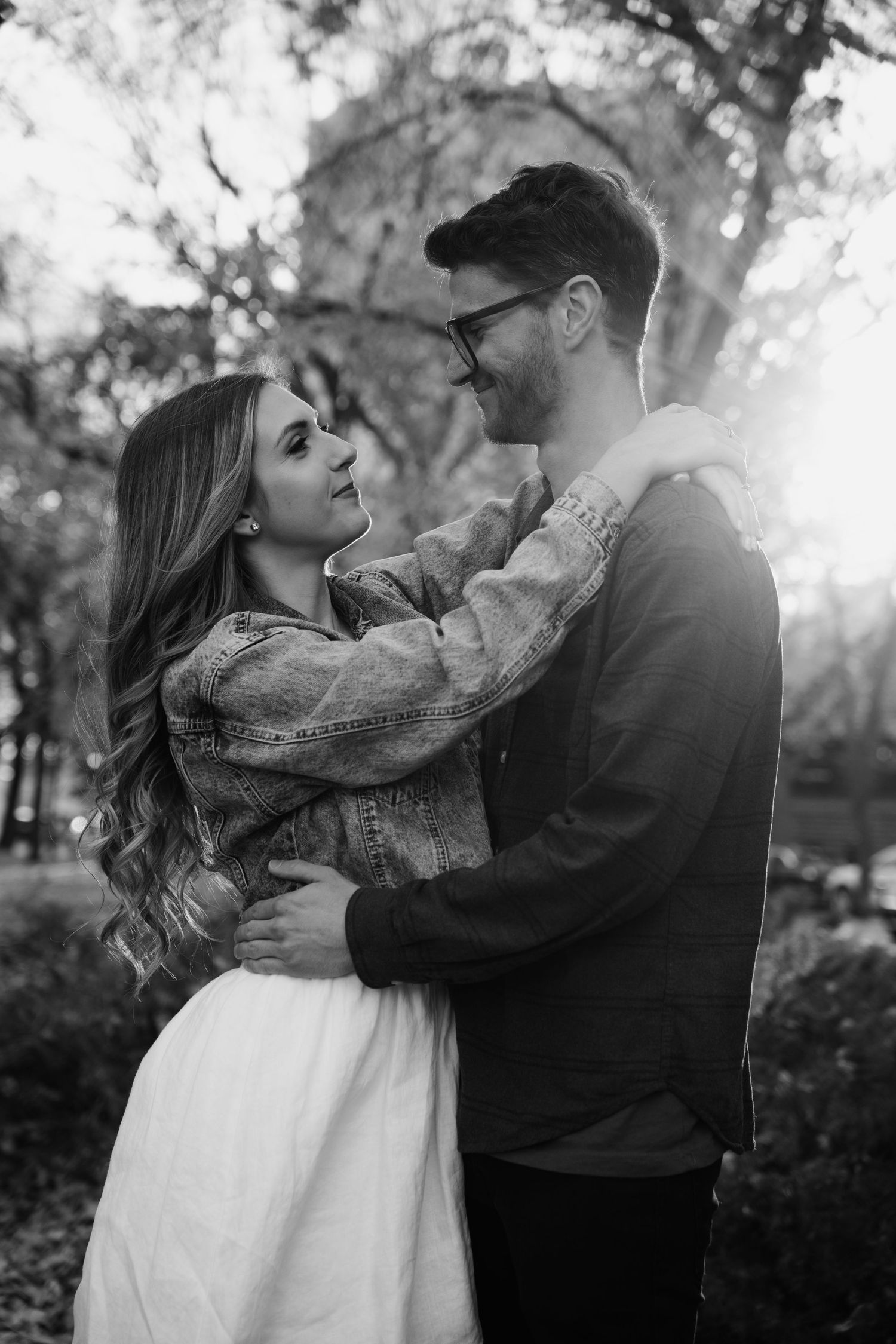 Romantic black and white portrait of couple sharing an intimate moment with a scarf.