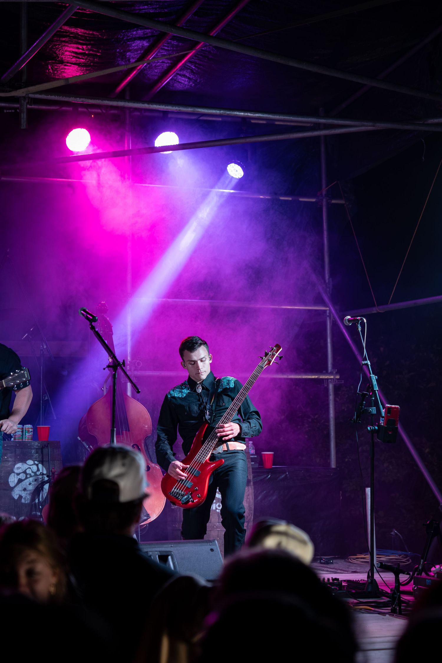 Rock concert scene with purple stage lighting and fog effects.