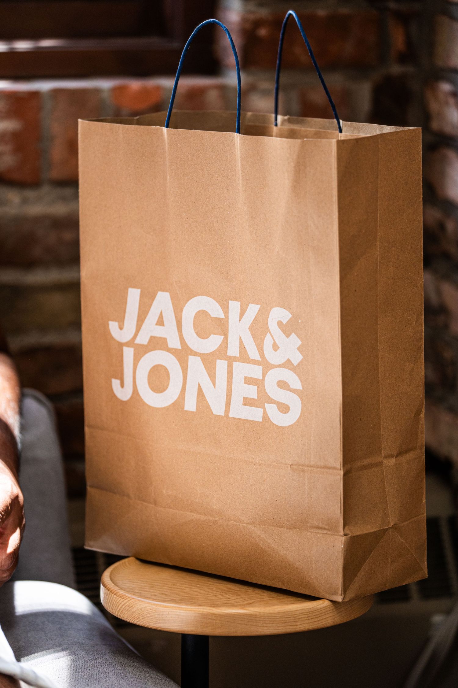 Brown paper shopping bags with Jack & Jones logo branding.