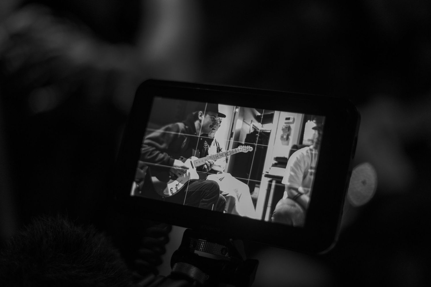 Dark monochrome film strips showing sequential frames from a performance or event.