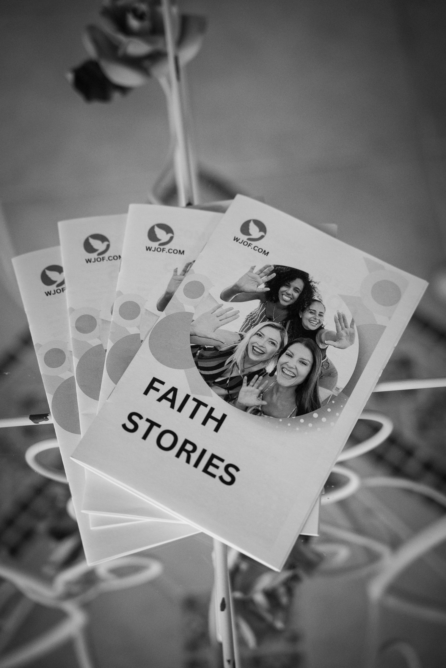 Black and white photo of cards labeled 'Faith Stories' arranged in a display.
