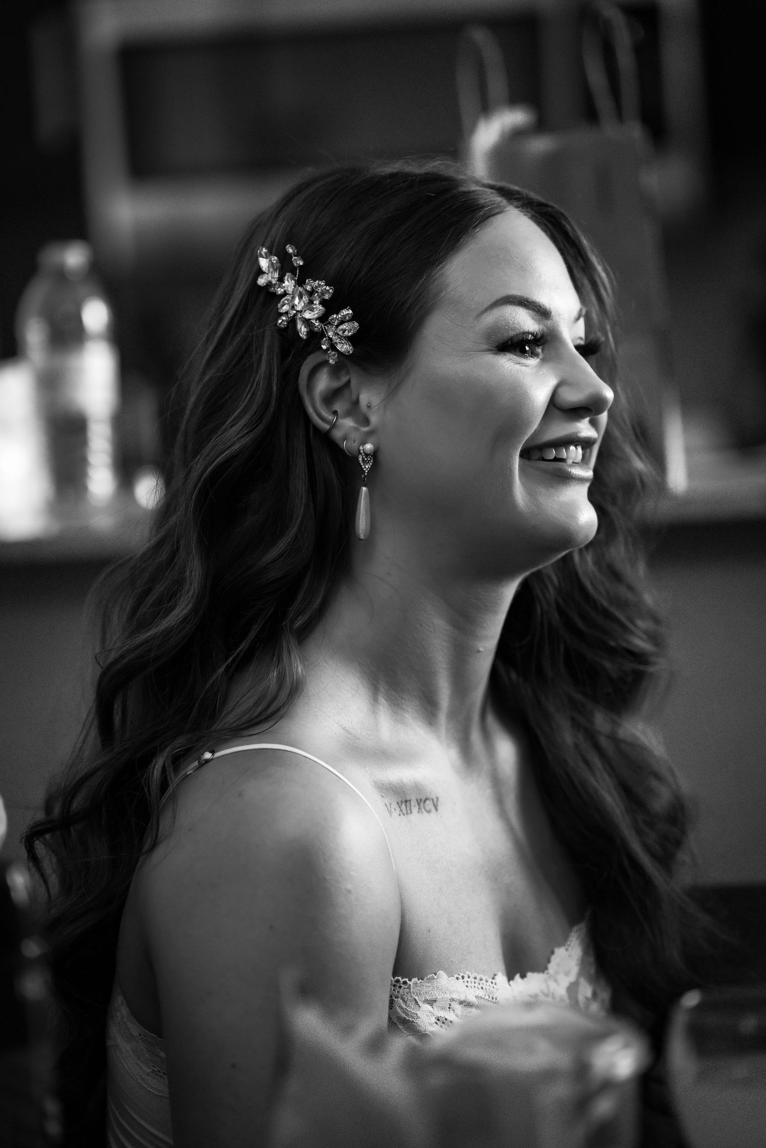 Artistic black and white portrait showing elegant bridal jewelry and hair styling.